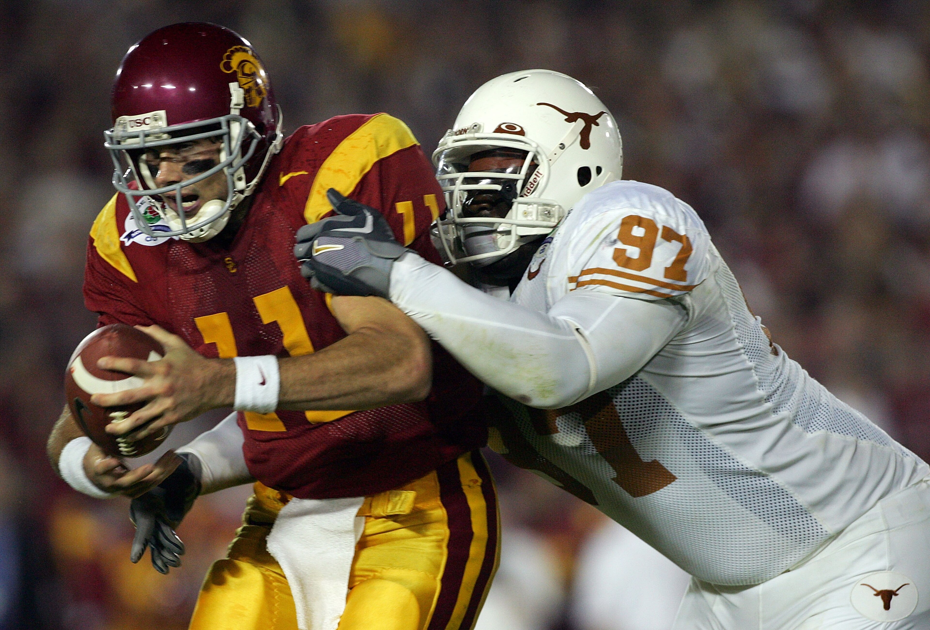 PASADENA, CA - JANUARY 04:  Quarterback Matt Leinart #11 of the USC Trojans is sacked by Frank Okam #97 of the Texas Longhorns during the second quarter of the BCS National Championship Rose Bowl Game at the Rose Bowl on January 4, 2006 in Pasadena, Calif