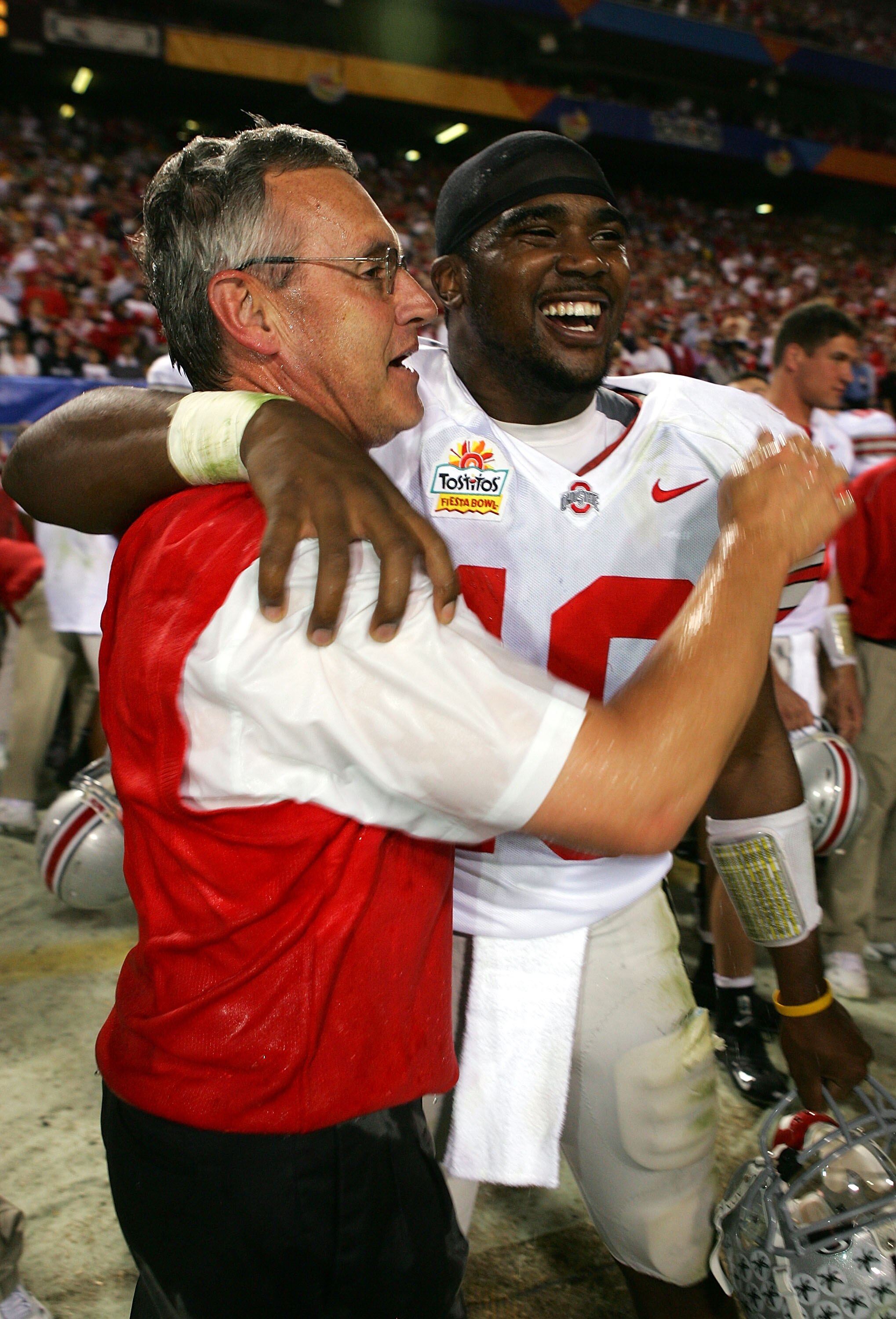 TEMPE, AZ - JANUARY 02:  Head coach Jim Tressel hugs quarterback Troy Smith #10 of the Ohio State Buckeyes after the Buckeyes defeated the Notre Dame Fighting Irish in the Tostito's Fiesta Bowl at Sun Devil Stadium on January 2, 2006 in Tempe, Arizona. Th