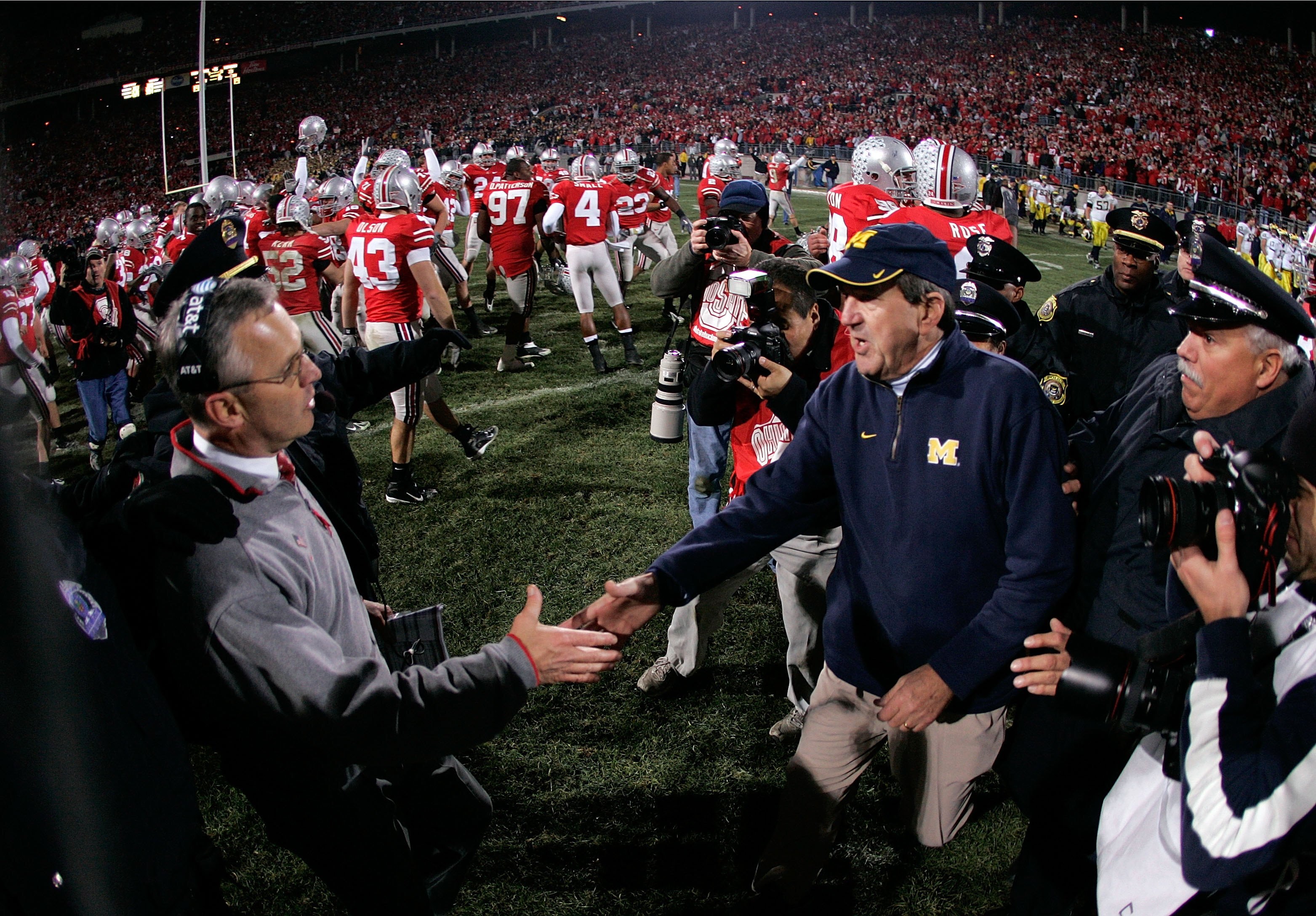 COLUMBUS, OH - NOVEMBER 18:  Head coach Jim Tressel of the Ohio State Buckeyes is congratulated by head coach Lloyd Carr of the Michigan Wolverines November 18, 2006 at Ohio Stadium in Columbus, Ohio. Ohio State won 42-39. (Photo by Gregory Shamus/Getty I