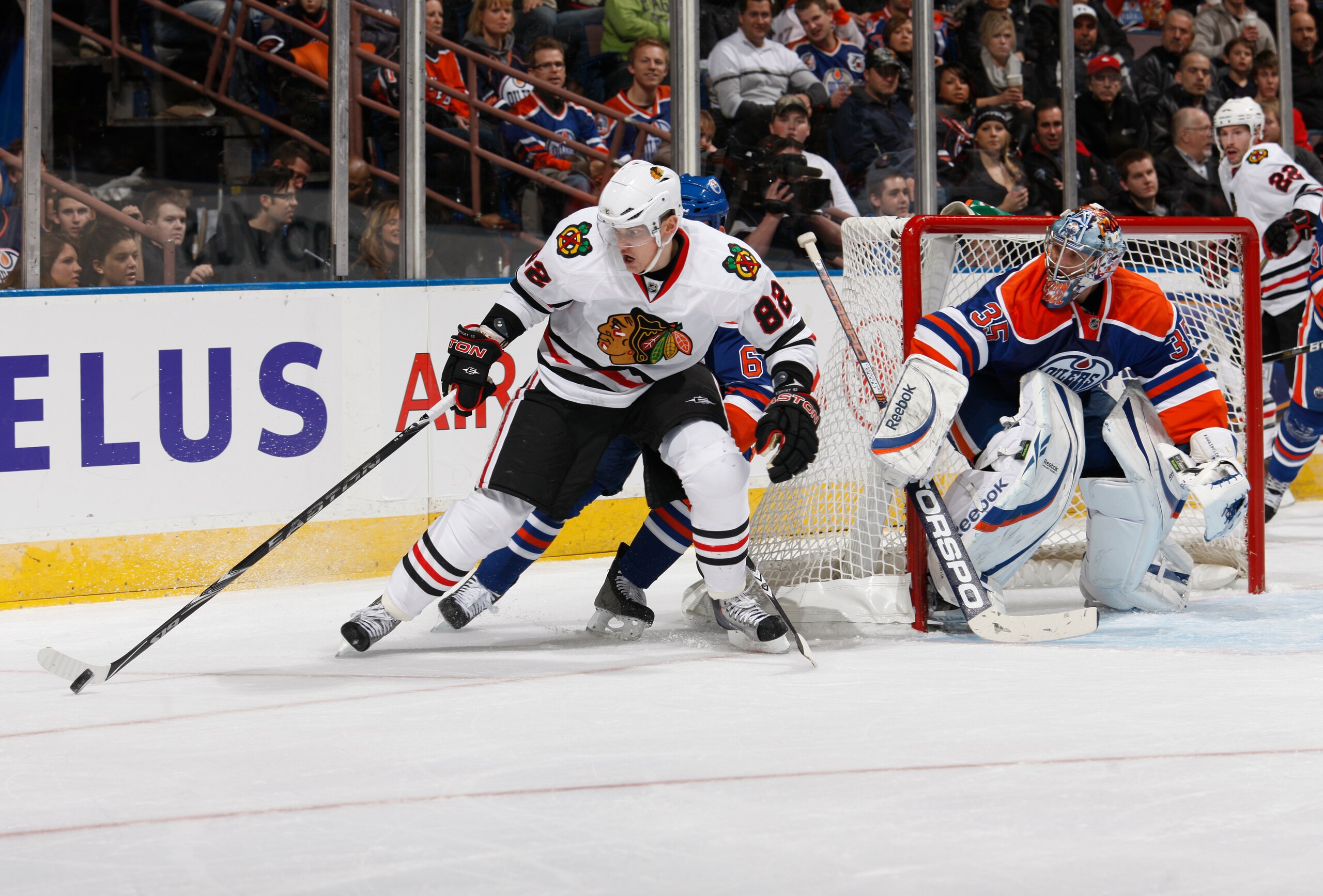 EDMONTON, CANADA - NOVEMBER 17:   Patrick Kane #88 of the Chicago Blackhawks is checked by Ryan Whitney #6 of the Edmonton Oilers in second-period action at Rexall Place November 17, 2010 in Edmonton, Alberta, Canada. (Photo by Dale MacMillan/Getty Images