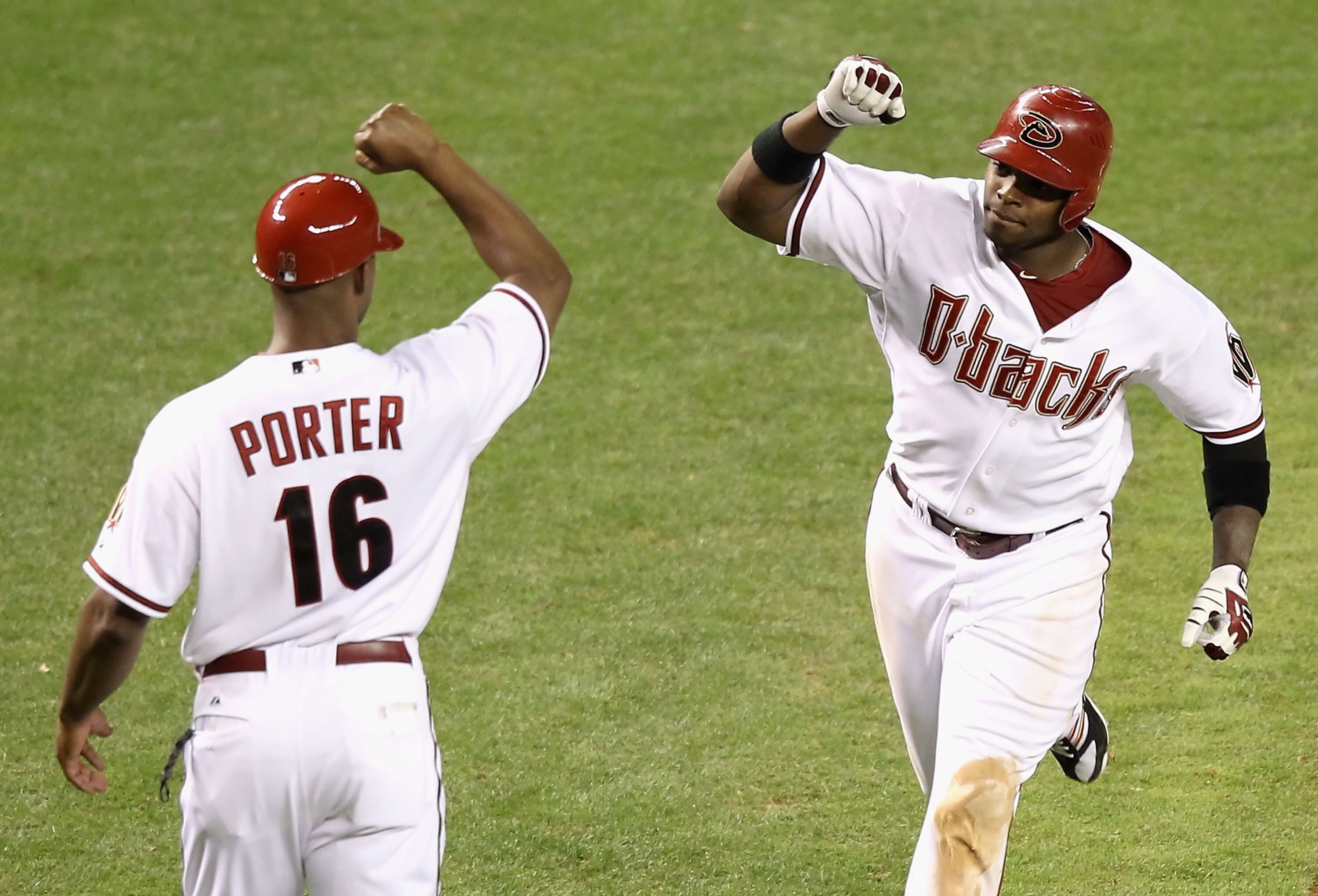 PHOENIX - JUNE 21:  Justin Upton #10 of the Arizona Diamondbacks is congratulated by third base coach Bo Porter #16 after hitting a 3 run home run against the New York Yankees during the eighth inning of the Major League Baseball game at Chase Field on Ju