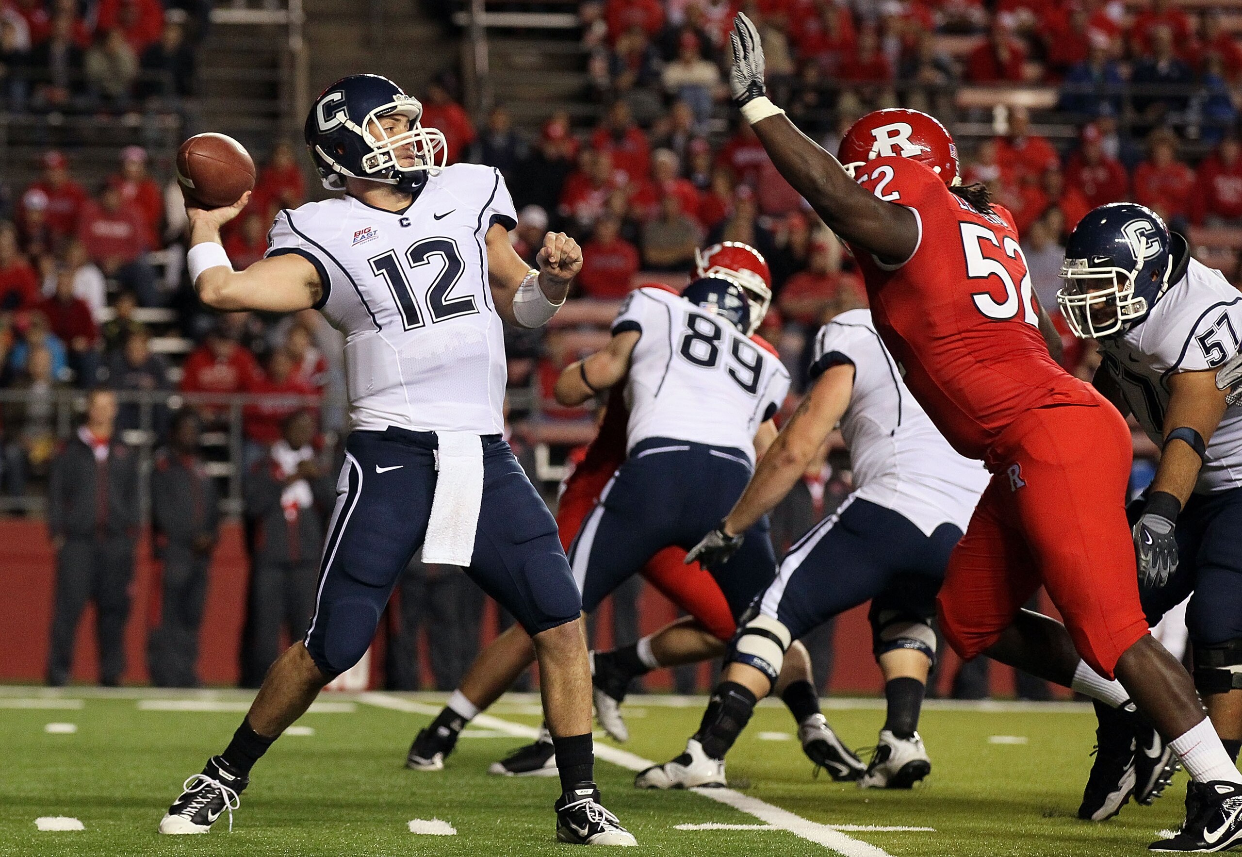 PISCATAWAY, NJ - OCTOBER 08:  Cody Endres #12 of the Connecticut Huskies throws a pass against the Rutgers Scarlet Knights at Rutgers Stadium on October 8, 2010 in Piscataway, New Jersey.  (Photo by Jim McIsaac/Getty Images)