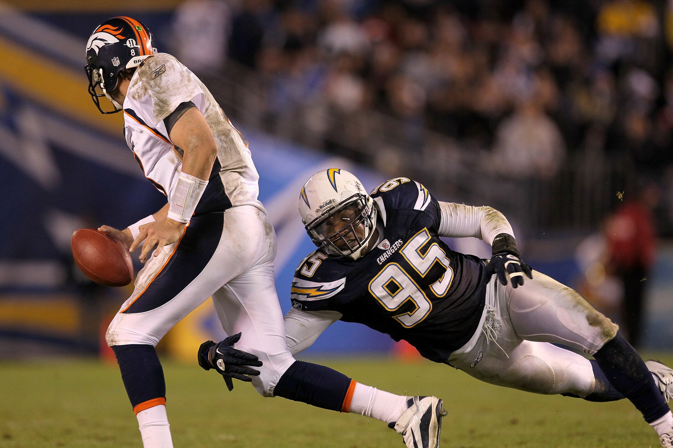 SAN DIEGO - NOVEMBER 22:  Linebacker Shaun Phillips #95 of the San Diego Chargers tackles quarterback Kyle Orton #8 of the Denver Broncos on an unsuccessful fleaflicker play at Qualcomm Stadium on November 22, 2010 in San Diego, California.  (Photo by Ste