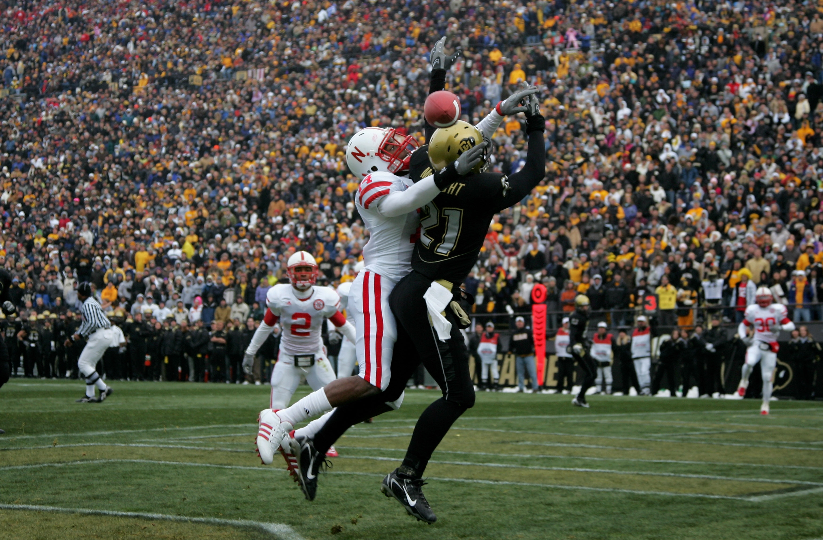 BOULDER, CO - NOVEMBER 23:  Cornerback Anthony Blue #14 of the Nebraska Cornhuskers breaks up a pass in the endzone intended for wide receiver Scotty McKnight #21 of the Colorado Buffaloes during Big 12 College Football action at Folsom Field on November 
