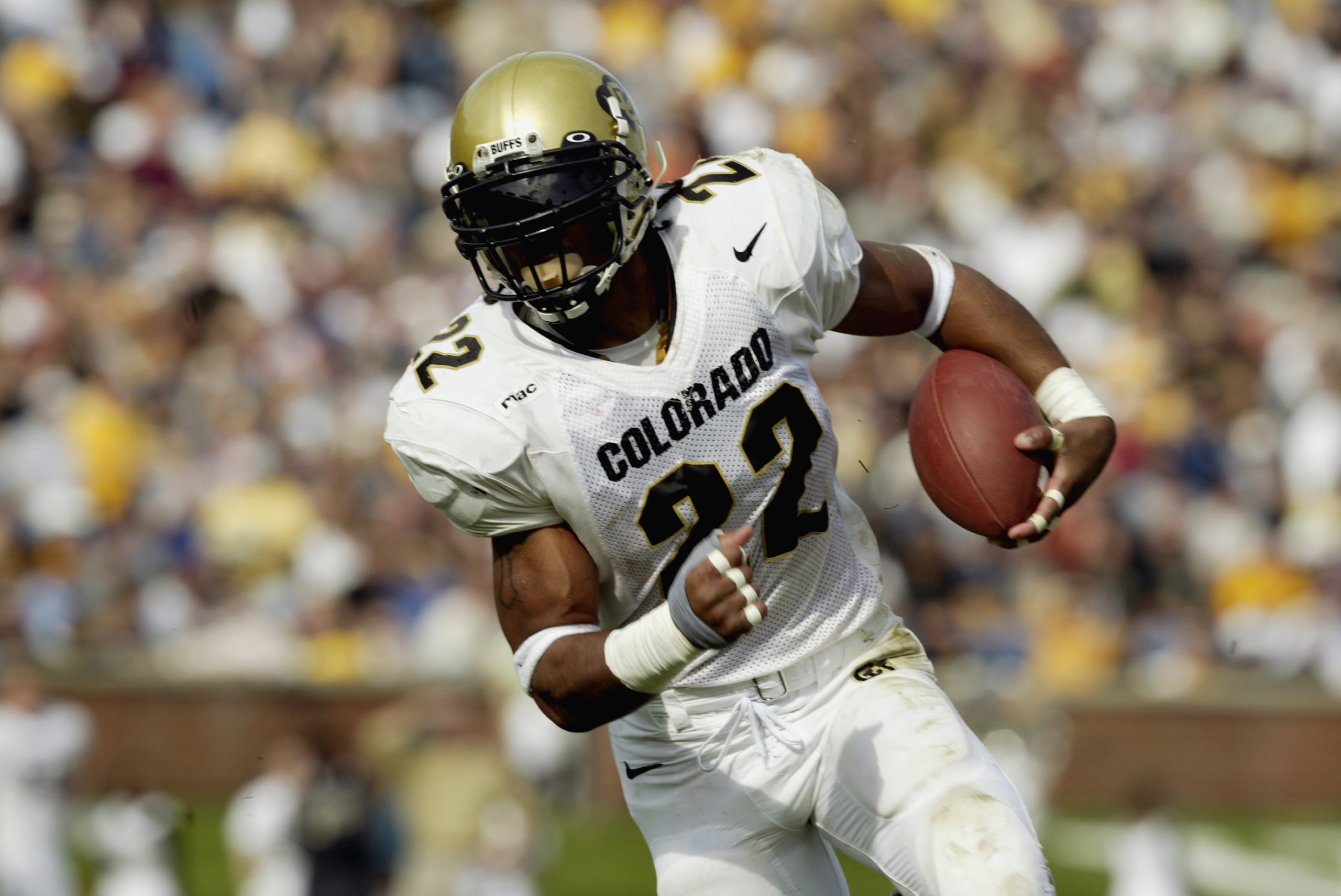 COLUMBIA, MISSOURI-NOVEMBER 9:  Chris Brown #22 of the Colorado Buffalos carries the ball during the game against the Missouri Tigers on November 9,2002 at Faurot Field in Columbia, Missouri. Colorado won 42-35 in overtime.(Photo by Elsa/Getty Images)
