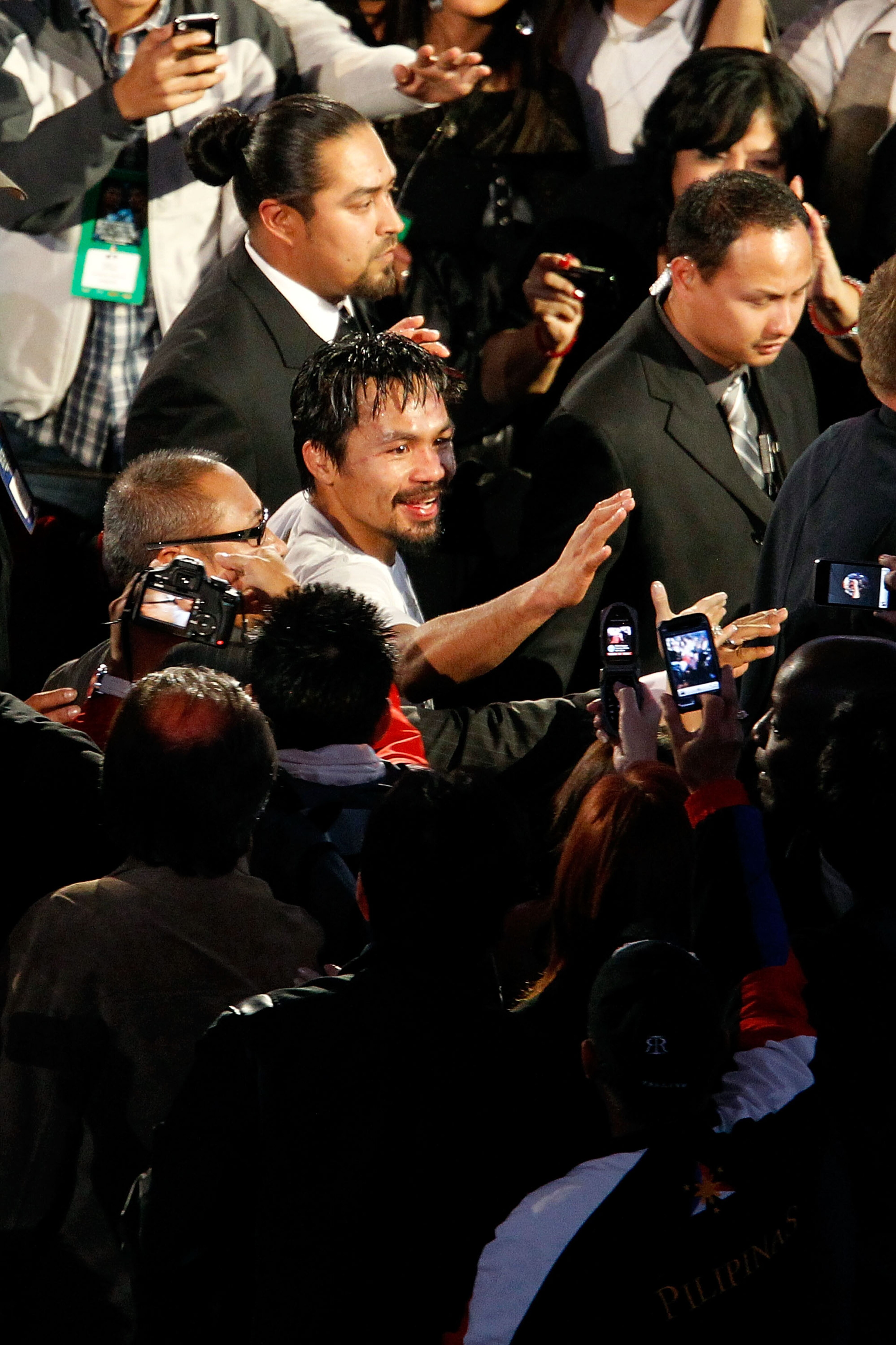 ARLINGTON, TX - NOVEMBER 13:  Manny Pacquiao (white trunks) of the Philippines celebrates as he leaves the ring after the won his bout against Antonio Margarito (black trunks) of Mexico during their WBC World Super Welterweight Title bout at Cowboys Stadi