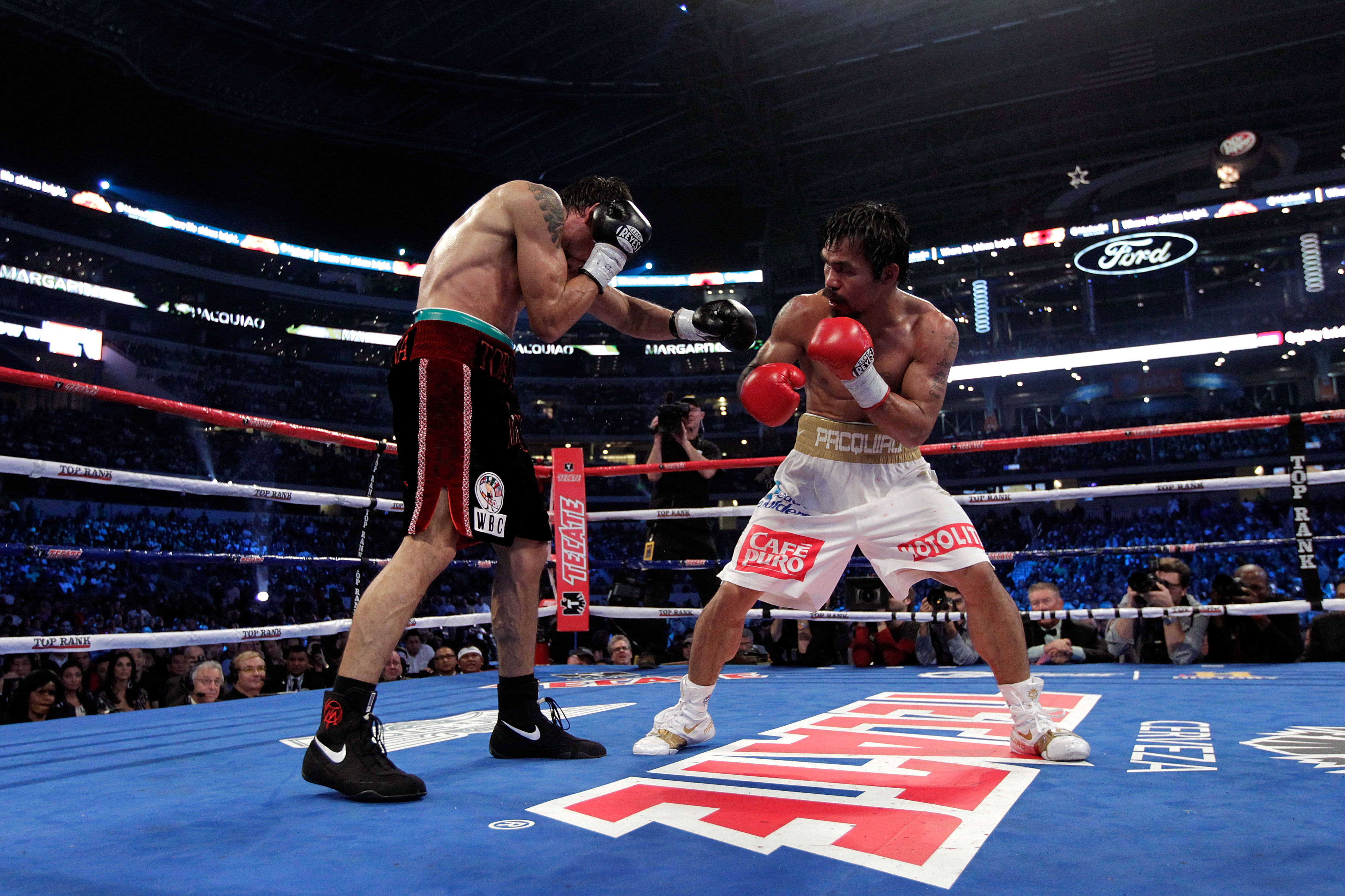 ARLINGTON, TX - NOVEMBER 13:  Manny Pacquiao (white trunks) of the Philippines fights against Antonio Margarito (black trunks) of Mexico during their WBC World Super Welterweight Title bout at Cowboys Stadium on November 13, 2010 in Arlington, Texas.  (Ph