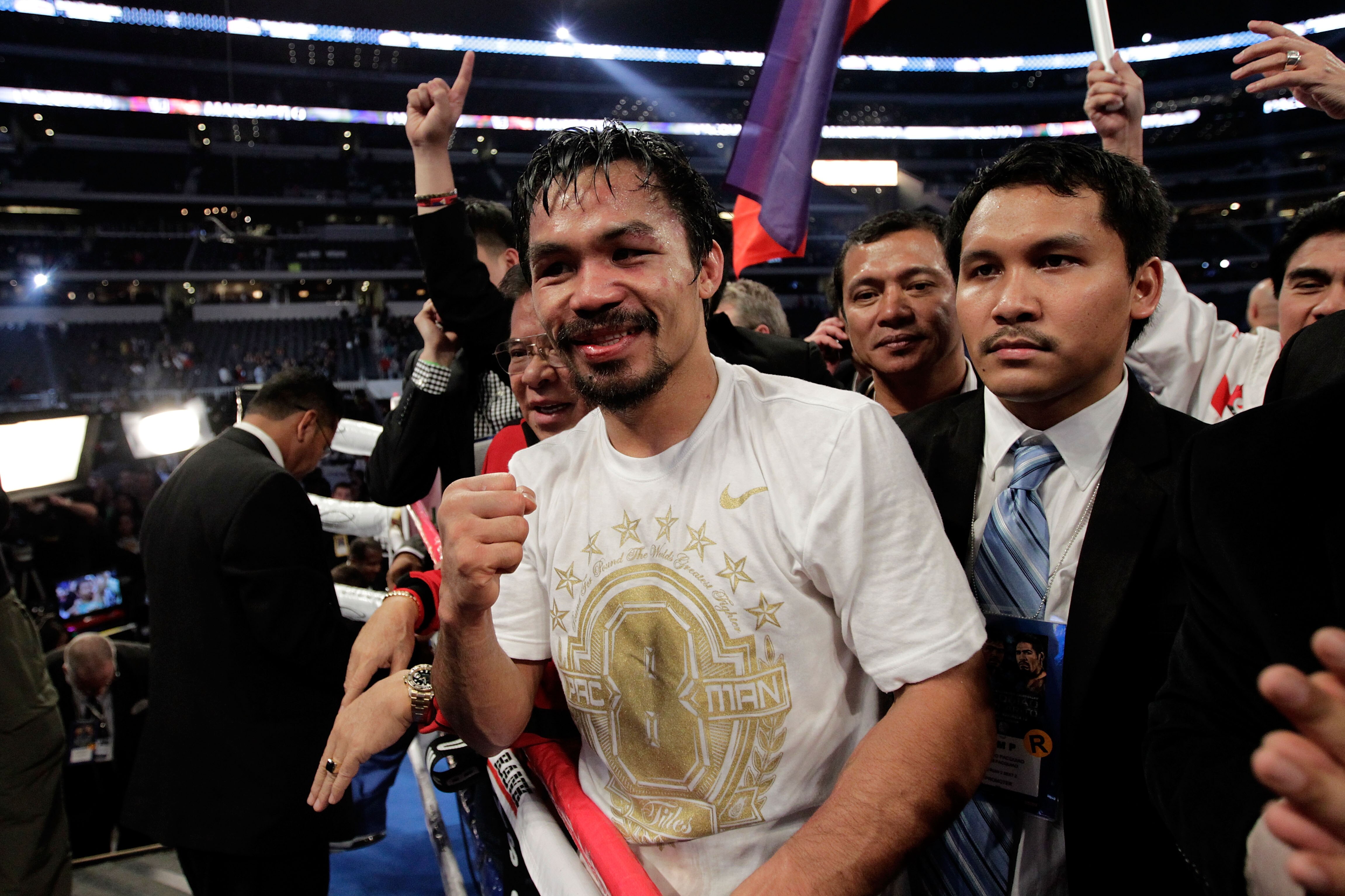 ARLINGTON, TX - NOVEMBER 13:  Manny Pacquiao (white trunks) of the Philippines celebrates after he was declared the winner by a unanimous decision against Antonio Margarito (black trunks) of Mexico during their WBC World Super Welterweight Title bout at C