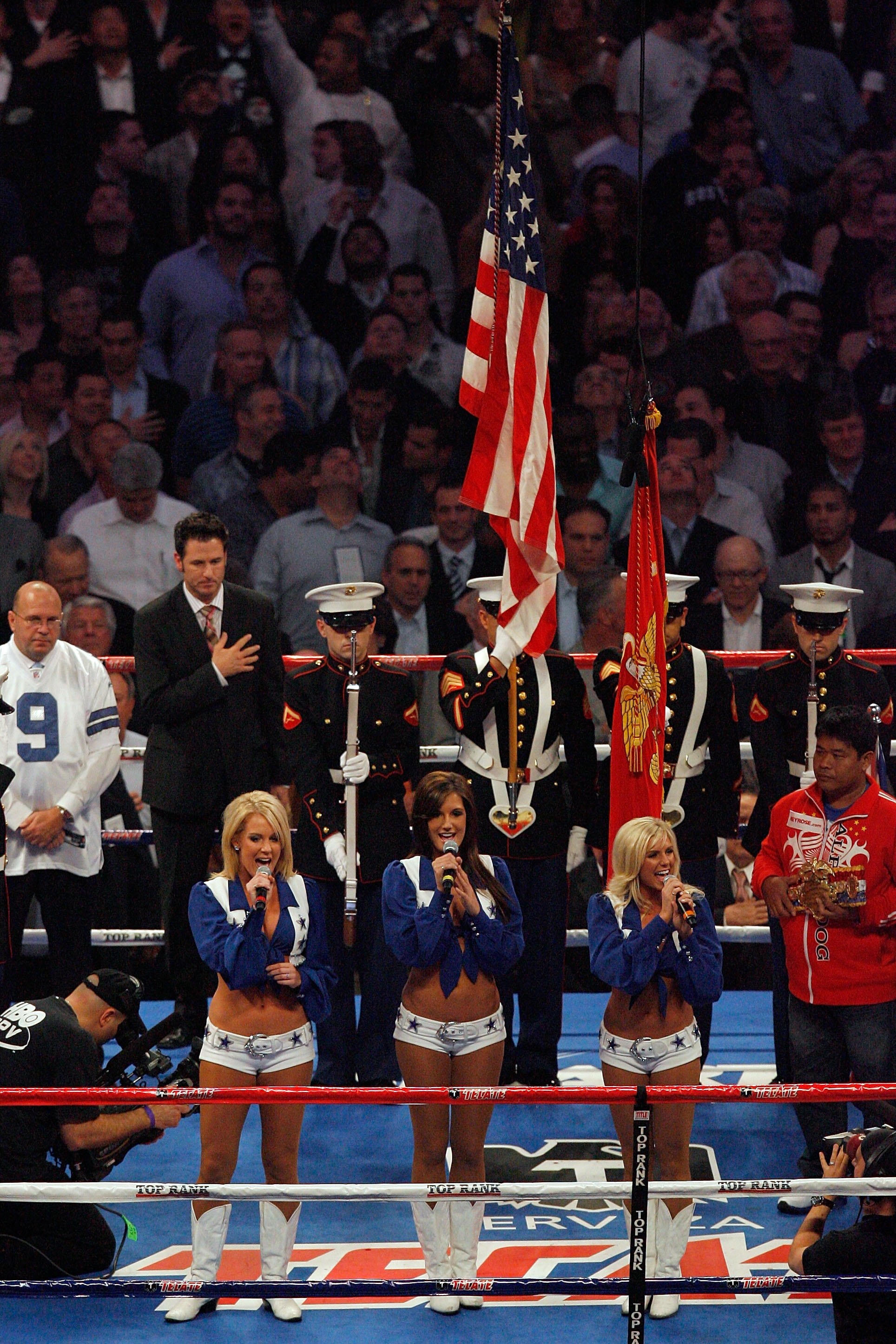 ARLINGTON, TX - MARCH 13:  Three Dallas Cowboys cheerleaders sing the United States National Anthem before the fight between Manny Pacquiao of the Philippines and Joshua Clottey of Ghana during the WBO welterweight title fight at Cowboys Stadium on March 