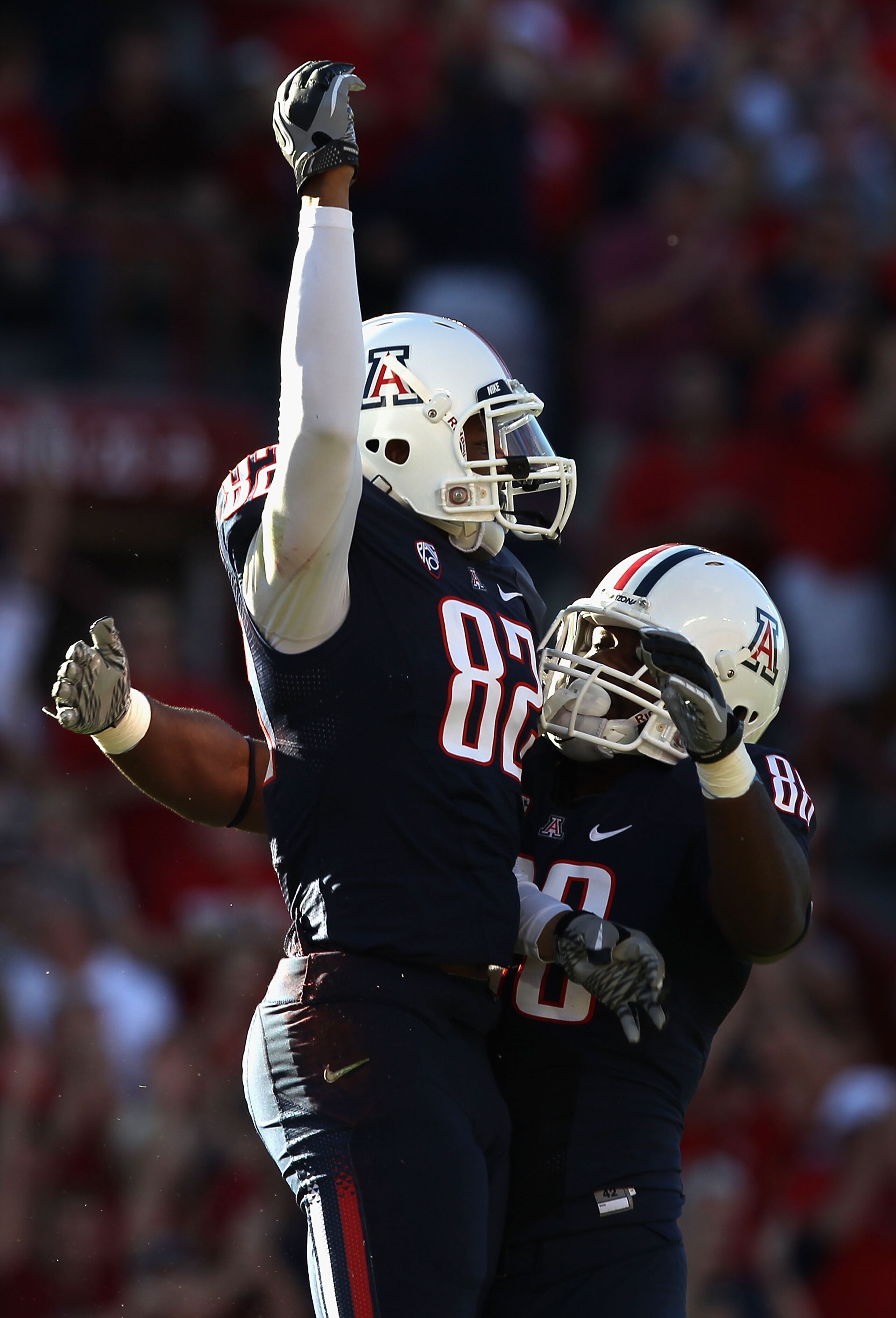 TUCSON, AZ - OCTOBER 09: Wide receiver Juron Criner #82 of the Arizona Wildcats celebrates with teammate Tyler Perry #88 after Criner caught a 45 yard touchdown reception against the Oregon State Beavers during the first quarter of the college football g TUCSON, AZ - OCTOBER 09: Wide receiver Juron Criner #82 of the Arizona Wildcats celebrates with teammate Tyler Perry #88 after Criner caught a 45 yard touchdown reception against the Oregon State Beavers during the first quarter of the college football g