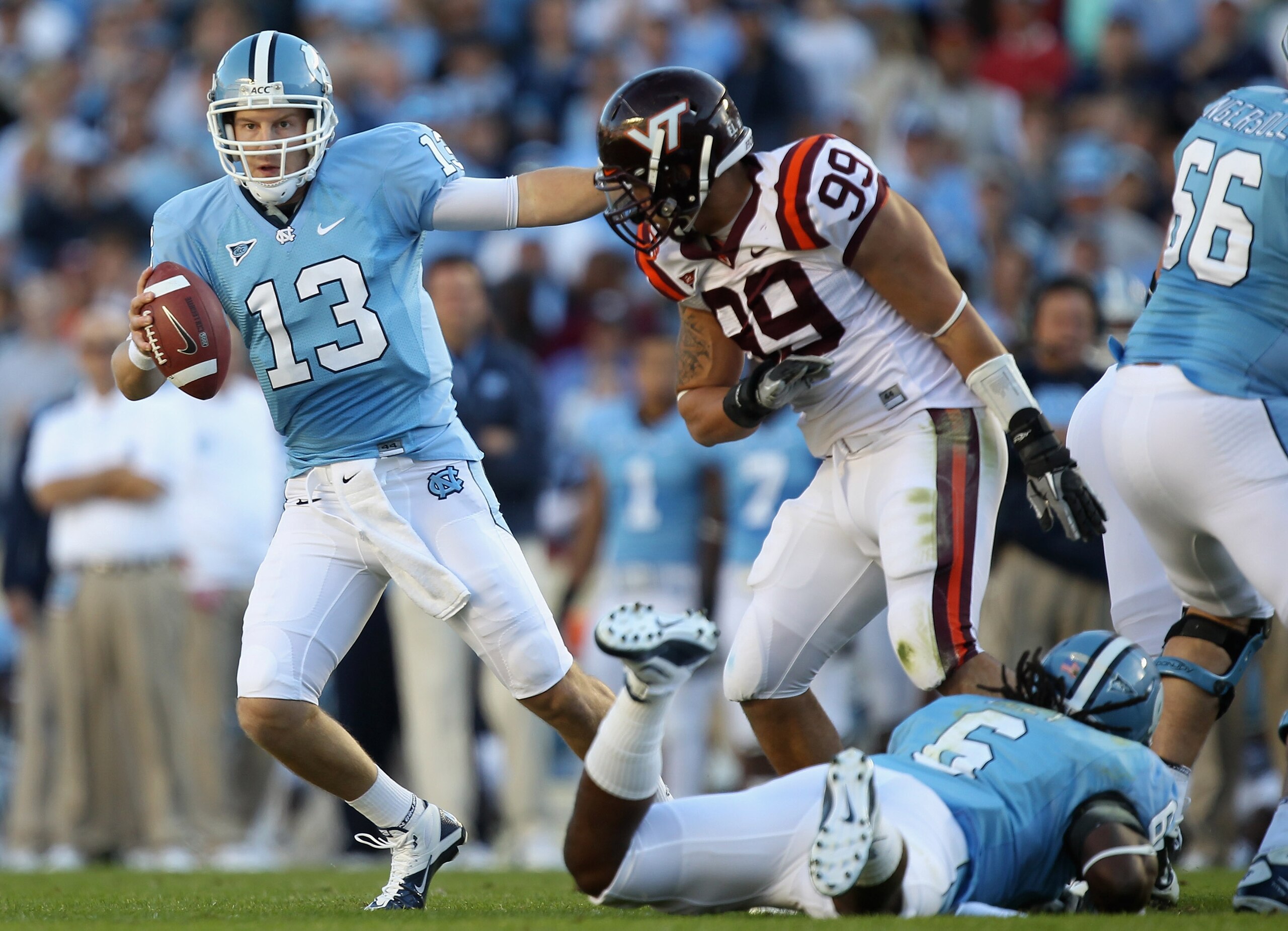 CHAPEL HILL, NC - NOVEMBER 13:  James Gayle #99 of the Virginia Tech Hokies runs after T.J. Yates #13 of the North Carolina Tar Heels during their game at Kenan Stadium on November 13, 2010 in Chapel Hill, North Carolina.  (Photo by Streeter Lecka/Getty I