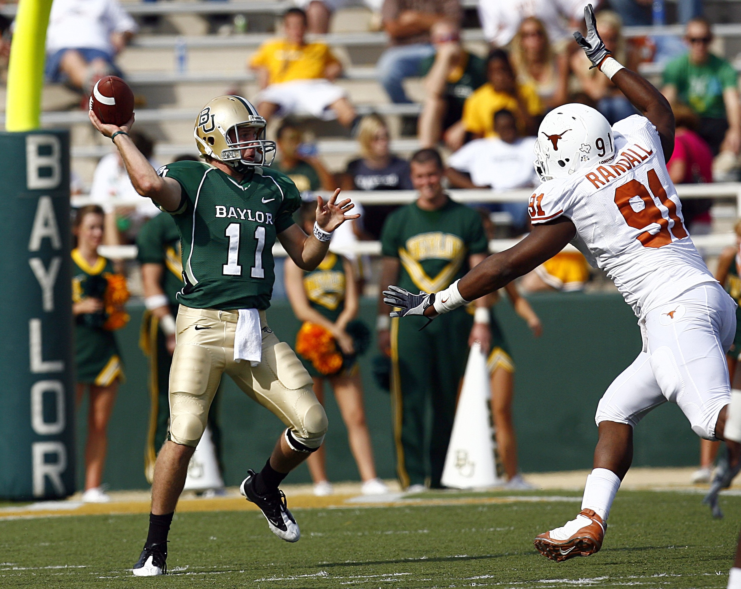 WACO, TX - NOVEMBER 14:  Quarterback Nick Florence #11 of the Baylor Bears looks for an open receiver as tackle Kheeston Randall #91 rushes in the second half on November 14, 2009 at Floyd Casey Stadium in Waco, Texas.  The Longhorns beat the Bears 47-14.