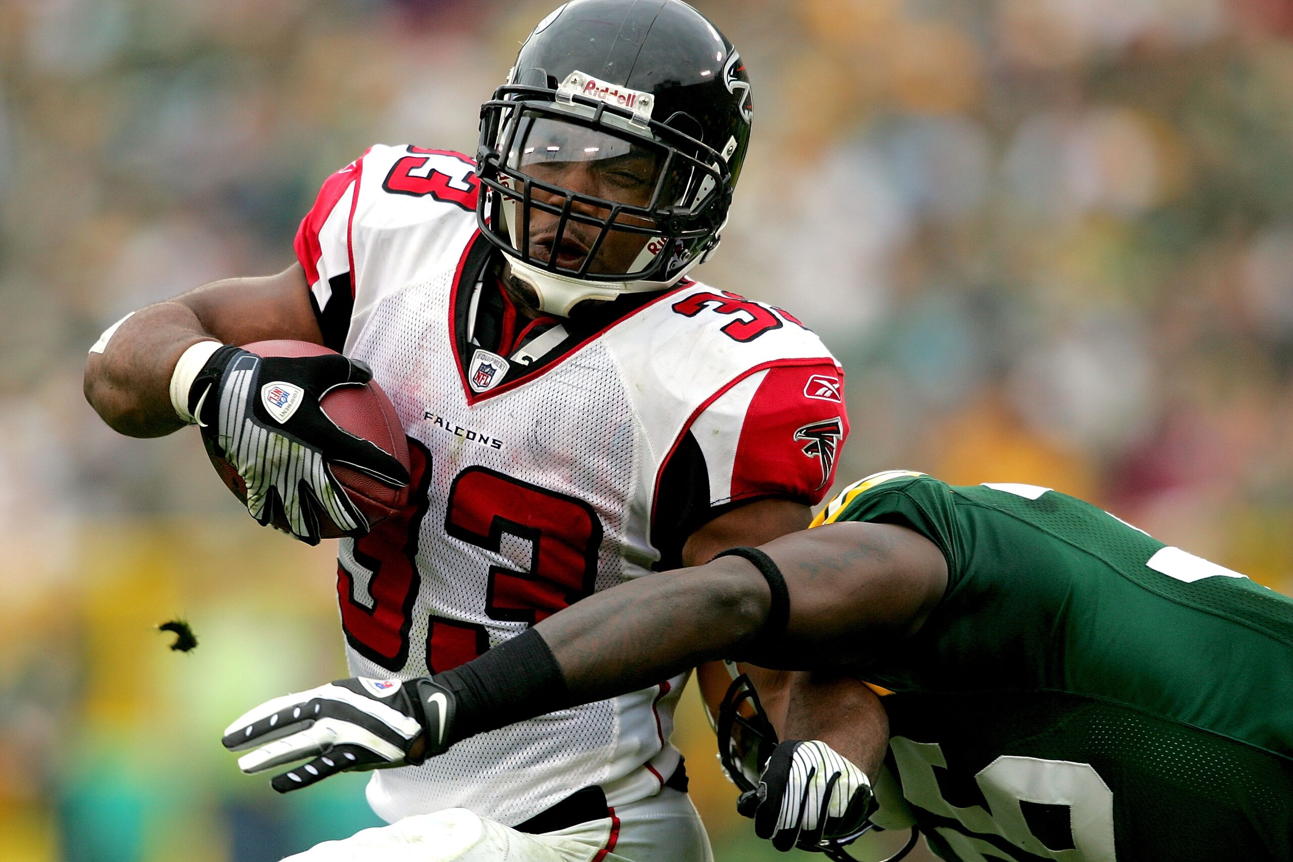 GREEN BAY, WI - OCTOBER 05:  Michael Turner #33 of the Atlanta Falcons carries the ball against Nick Collins #36 of the Green Bay Packers at Lambeu Field October 5, 2008 in Green Bay, Wisconsin.  (Photo by Matthew Stockman/Getty Images)