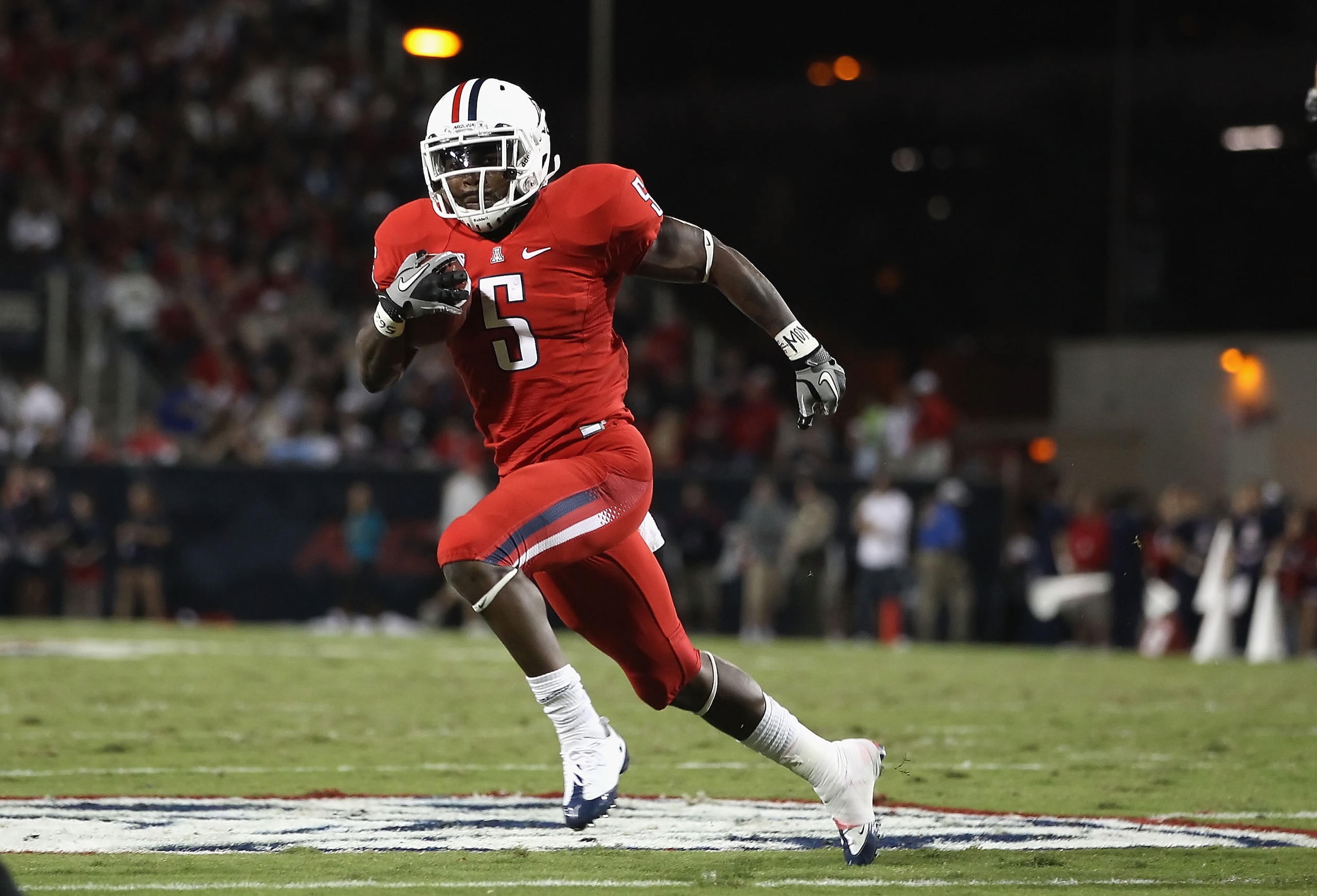 TUCSON, AZ - OCTOBER 23: Runningback Nic Grigsby #5 of the Arizona Wildcats runs with the ball during the college football game against the Washington Huskies at Arizona Stadium on October 23, 2010 in Tucson, Arizona. The Wildcats defeated the Huskies TUCSON, AZ - OCTOBER 23: Runningback Nic Grigsby #5 of the Arizona Wildcats runs with the ball during the college football game against the Washington Huskies at Arizona Stadium on October 23, 2010 in Tucson, Arizona. The Wildcats defeated the Huskies