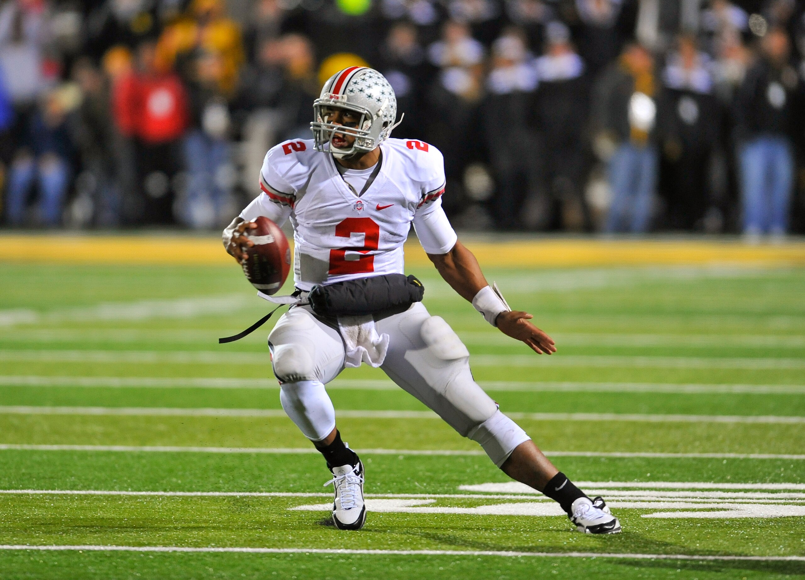 IOWA CITY, IA - NOVEMBER 20: Quarterback Terrelle Pryor #2 of the Ohio State Buckeyes scrambles for yards under pressure from University of Iowa Hawkeyes defenders during the second half of play at Kinnick Stadium on November 20, 2010 in Iowa City, Iowa. IOWA CITY, IA - NOVEMBER 20: Quarterback Terrelle Pryor #2 of the Ohio State Buckeyes scrambles for yards under pressure from University of Iowa Hawkeyes defenders during the second half of play at Kinnick Stadium on November 20, 2010 in Iowa City, Iowa.