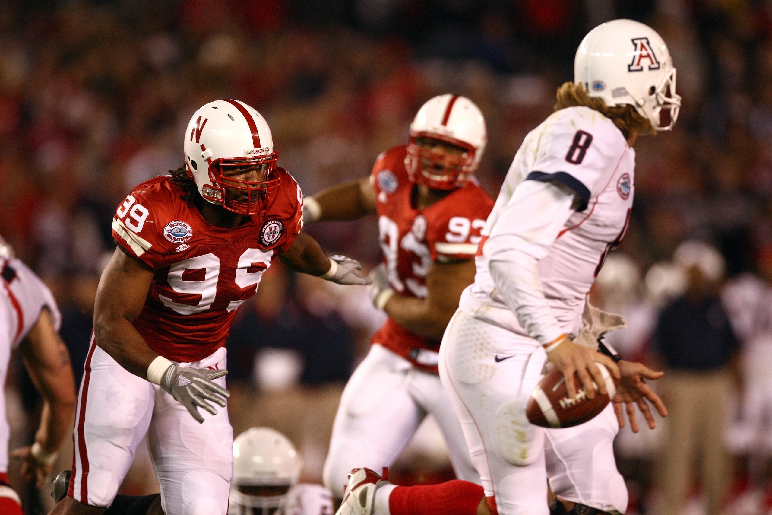 SAN DIEGO - DECEMBER 30: Barry Turner #99 of the University of Nebraska Cornhuskers rushes after quarterback Nick Foles #8 of the University of Arizona Wildcats during the Pacific Life Holiday Bowl on December 30, 2009 at Qualcomm Stadium in San Diego, C SAN DIEGO - DECEMBER 30: Barry Turner #99 of the University of Nebraska Cornhuskers rushes after quarterback Nick Foles #8 of the University of Arizona Wildcats during the Pacific Life Holiday Bowl on December 30, 2009 at Qualcomm Stadium in San Diego, C