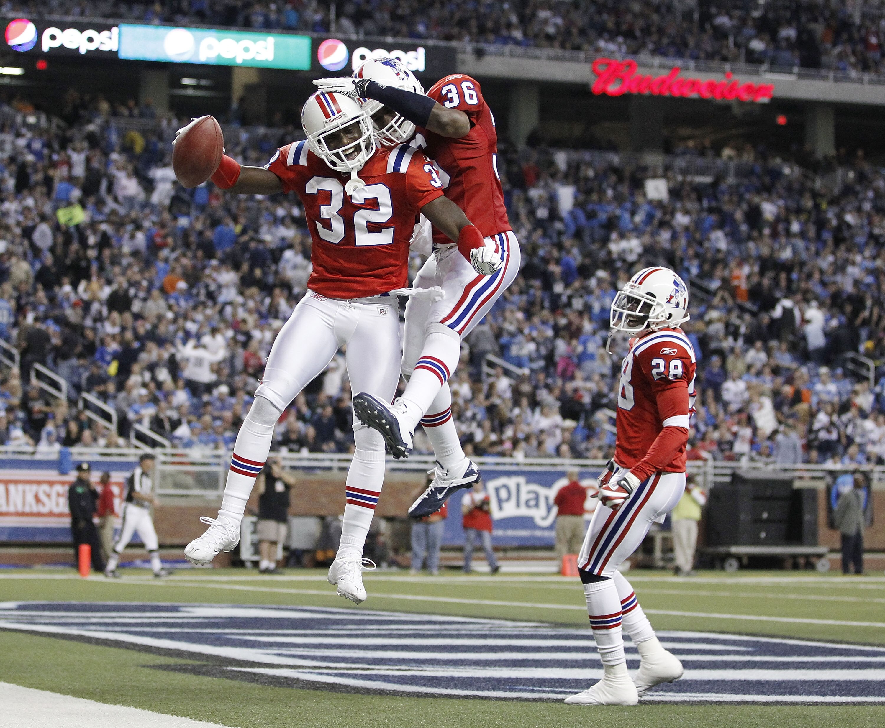 DETROIT - NOVEMBER 25: Devin McCourty #32 of the New England Patriots celebrates a fourth quarter interception with James Sanders #36 and Darius Butler #28 while playing the Detroit Lions on November 25, 2010 at Ford Field in Detroit, Michigan. New Englan