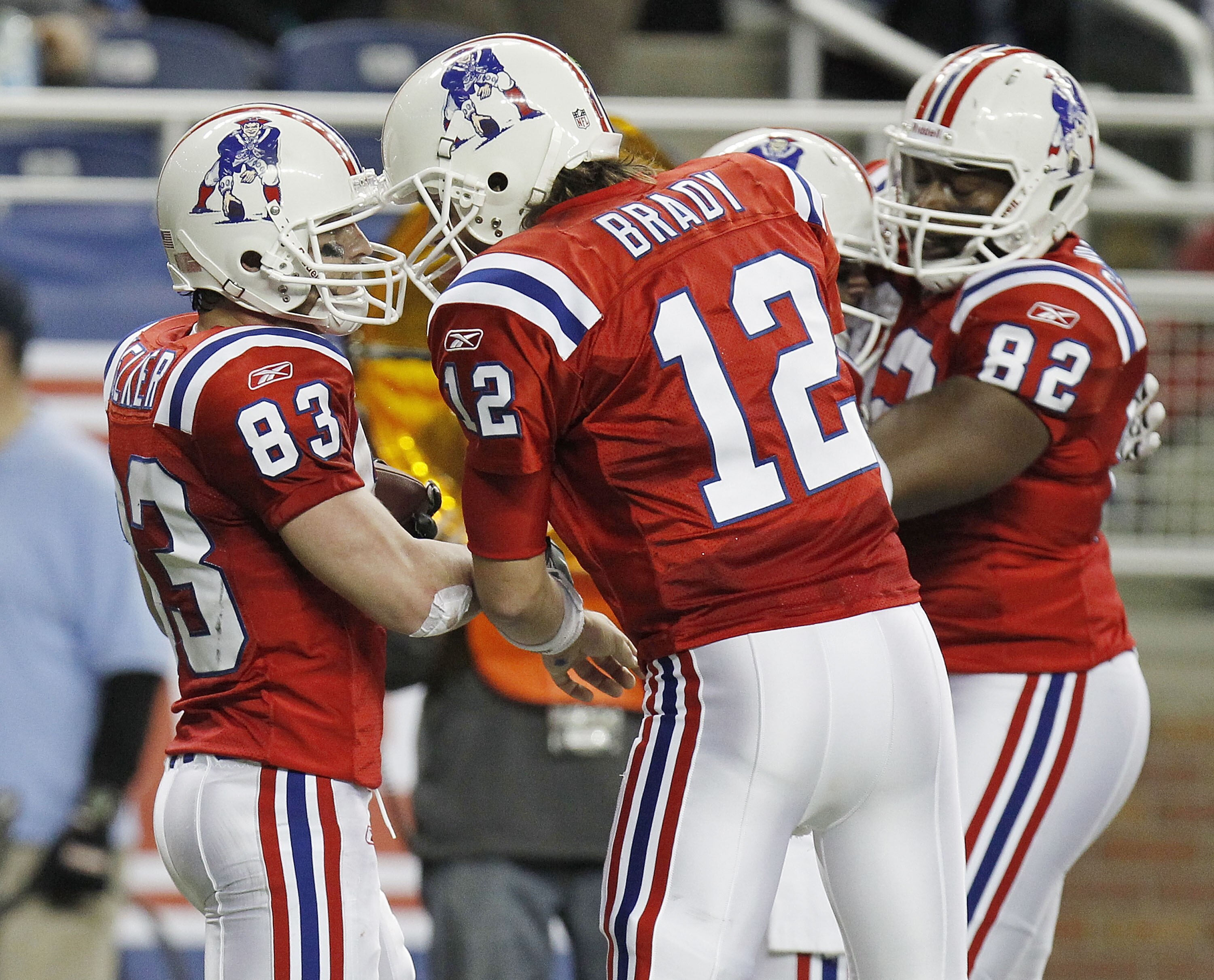 DETROIT - NOVEMBER 25:  Wes Welker #83 of the New England Patriots celebrates a fourth quarter touchdown with Tom Brady #12 and Alge Crumpler #82 while playing the Detroit Lions on November 25, 2010 at Ford Field in Detroit, Michigan. New England won the