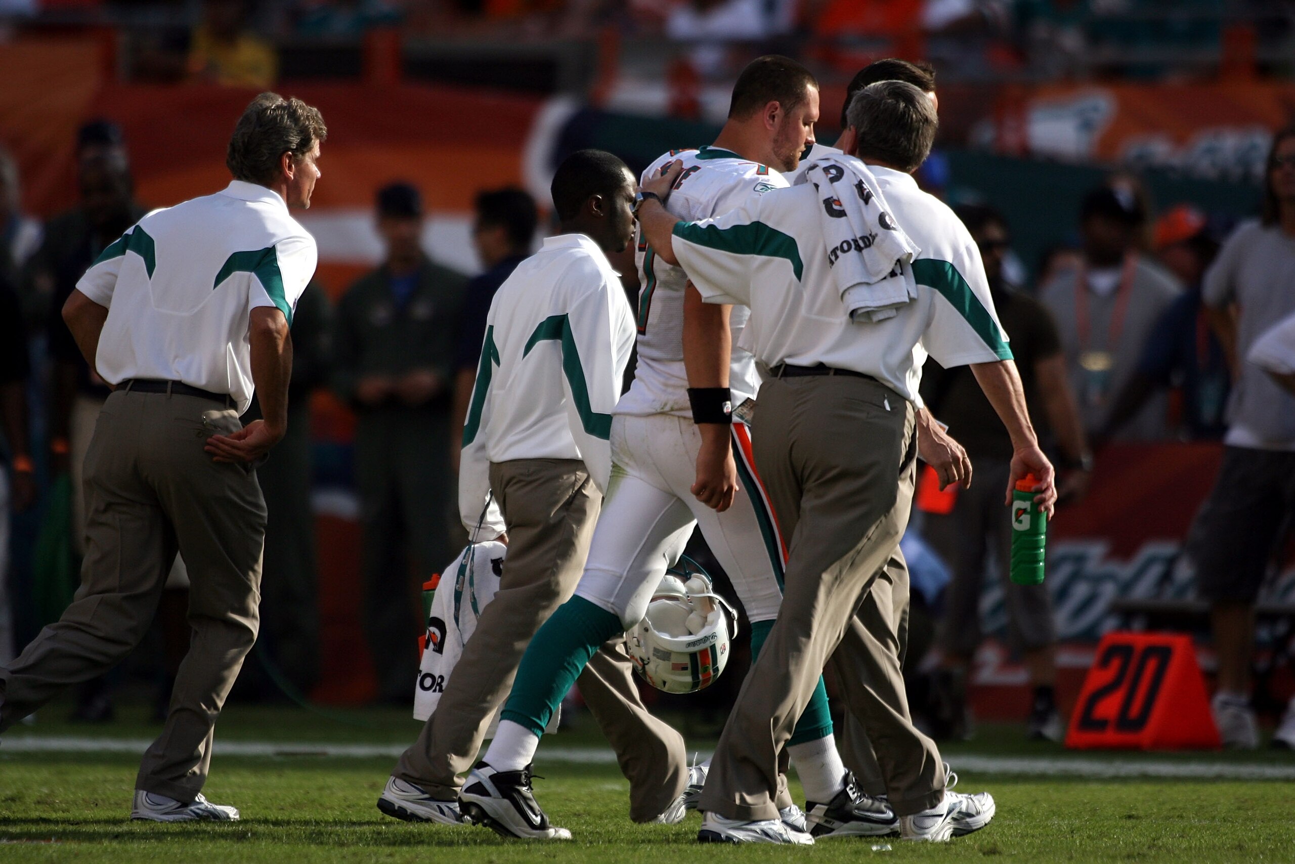 MIAMI - NOVEMBER 14:  Quarterback Chad Henne #7 of the Miami Dolphins is helped on the field  against the Tennessee Titans at Sun Life Stadium on November 14, 2010 in Miami, Florida.  (Photo by Marc Serota/Getty Images)