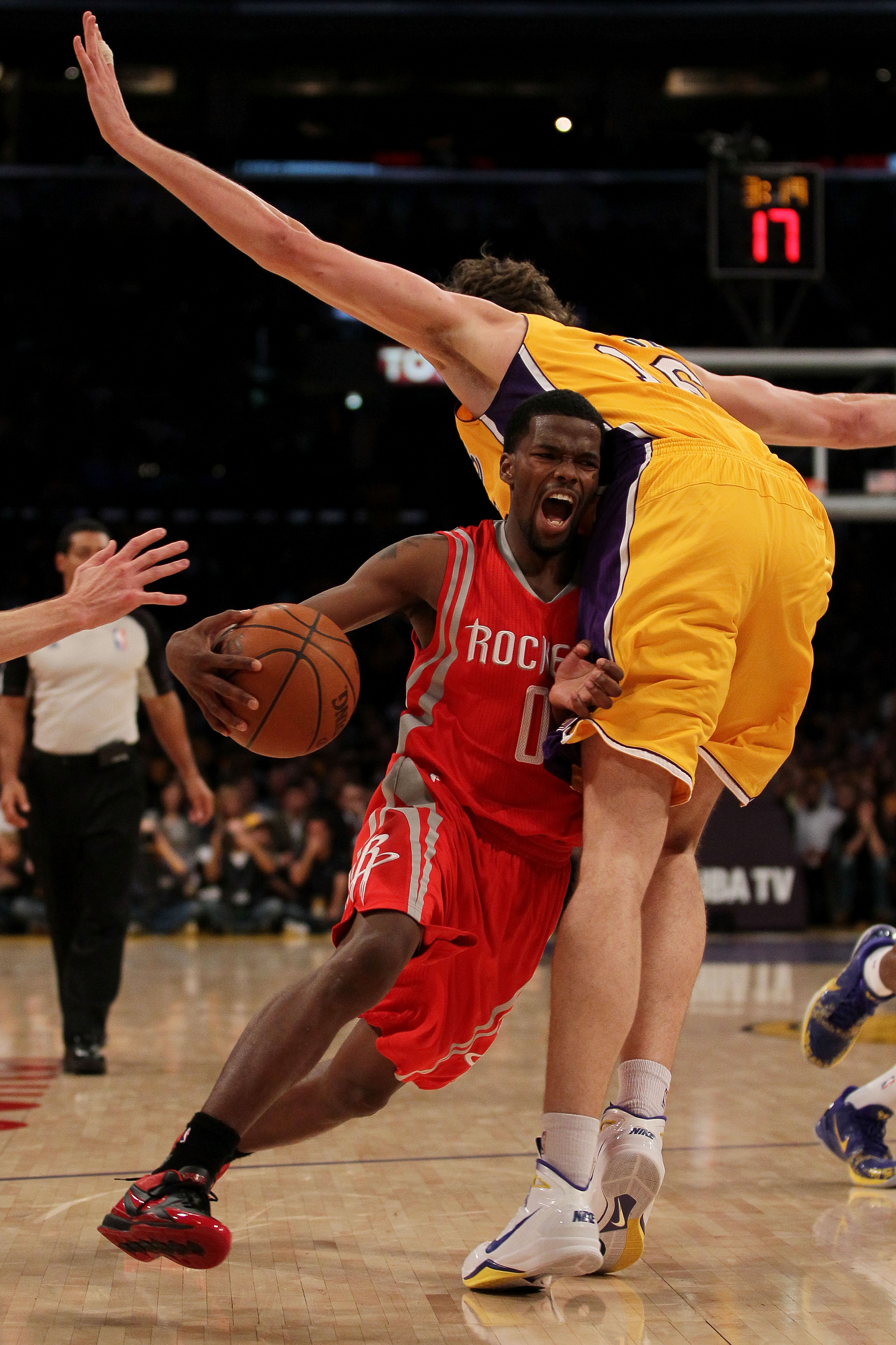 LOS ANGELES, CA - OCTOBER 26:  Aaron Brooks #0 of the Houston Rockets drives with the ball against Pau Gasol #16 of the Los Angeles Lakers during their opening night game at Staples Center on October 26, 2010 in Los Angeles, California. NOTE TO USER: User