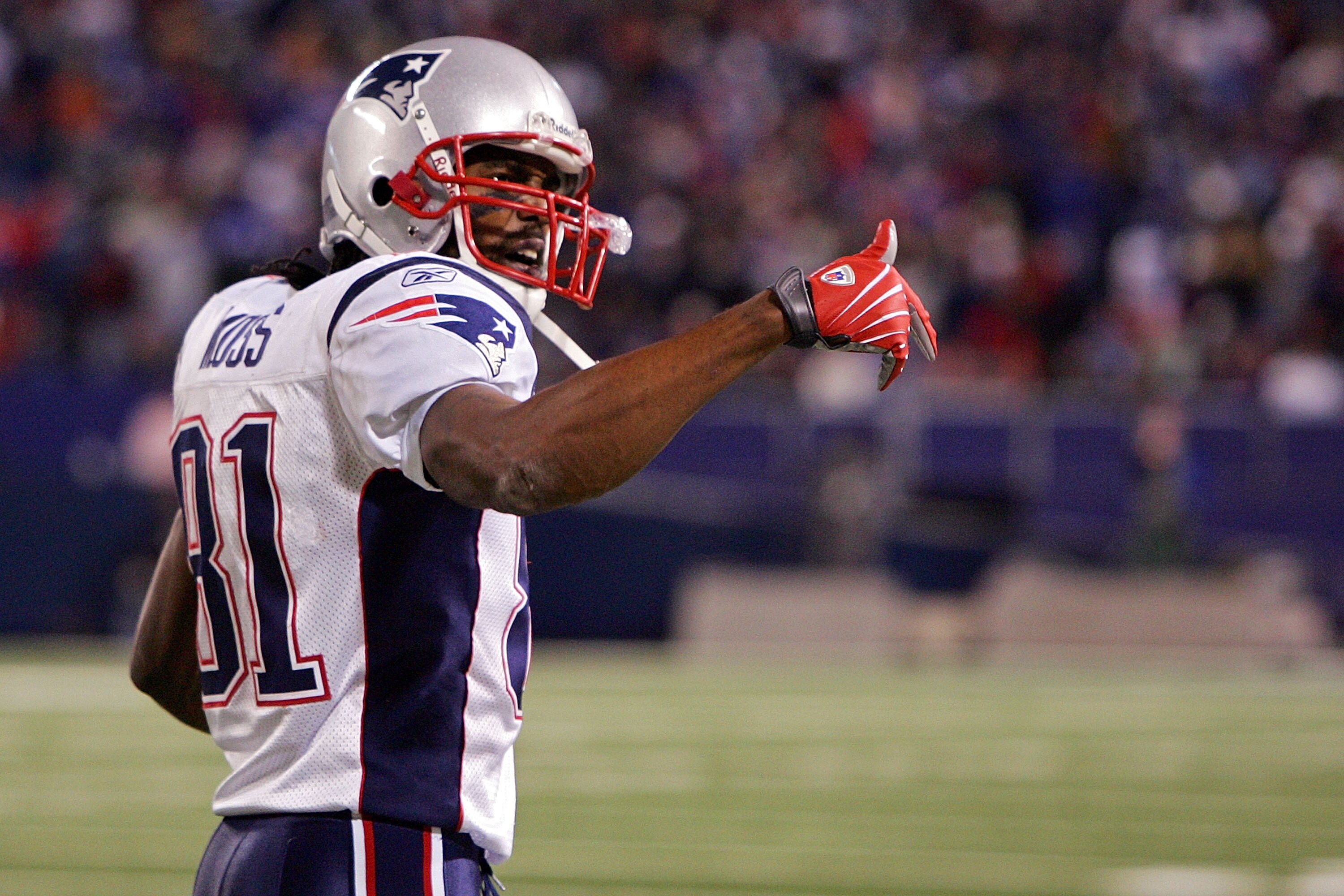 EAST RUTHERFORD, NJ - DECEMBER 29:  Randy Moss  #81 of the New England Patriots celebrates the touchdown of Laurence Maroney #39 in the fourth quarter against  the New York Giants on December 29, 2007 at Giants Stadium in East Rutherford, New Jersey.  (Ph
