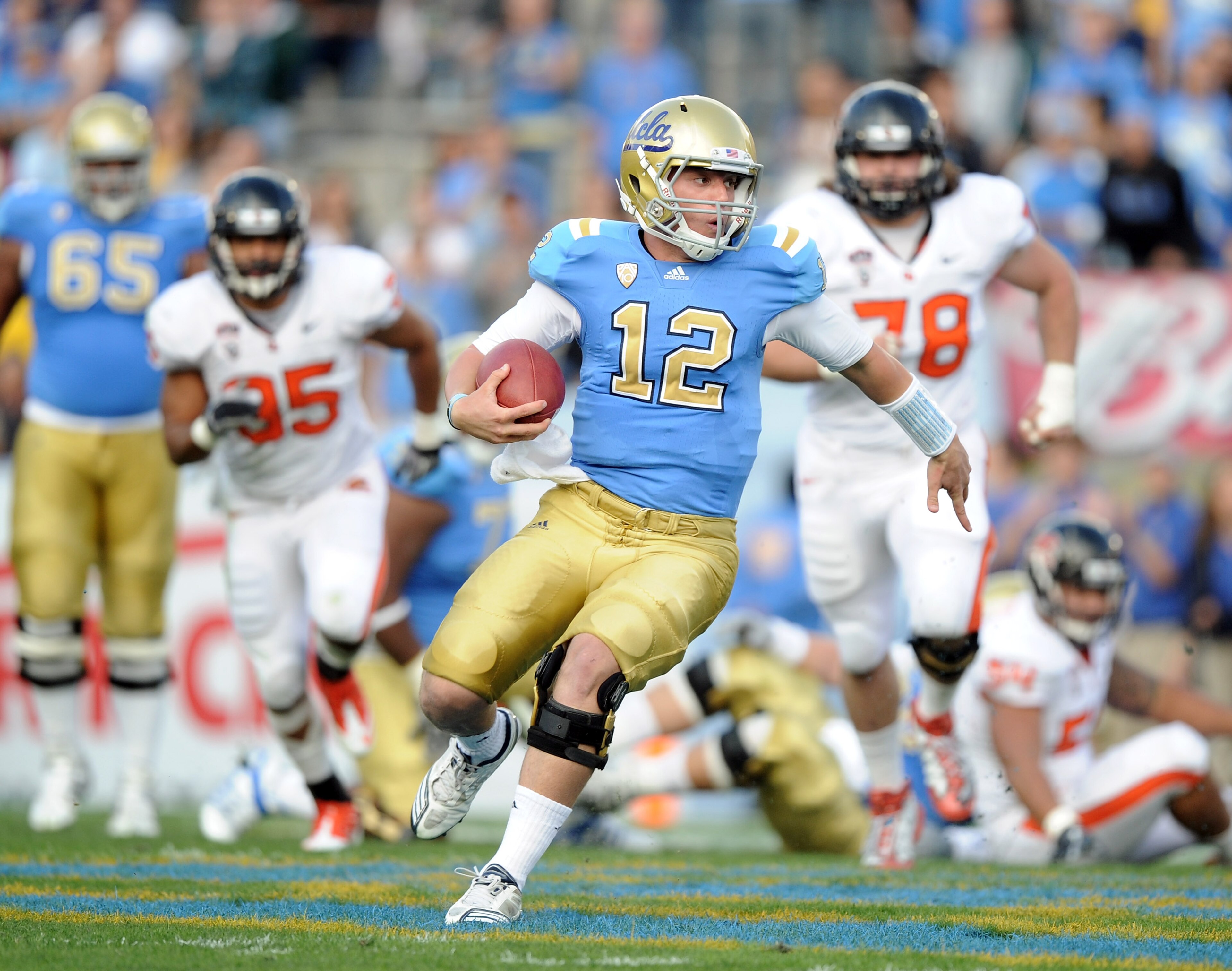 PASADENA, CA - NOVEMBER 06:  Richard Brehaut #12 of the UCLA Bruins scrambles for yards out of the pocket against the Oregon State Beavers during the first quarter at the Rose Bowl on November 6, 2010 in Pasadena, California.  (Photo by Harry How/Getty Im