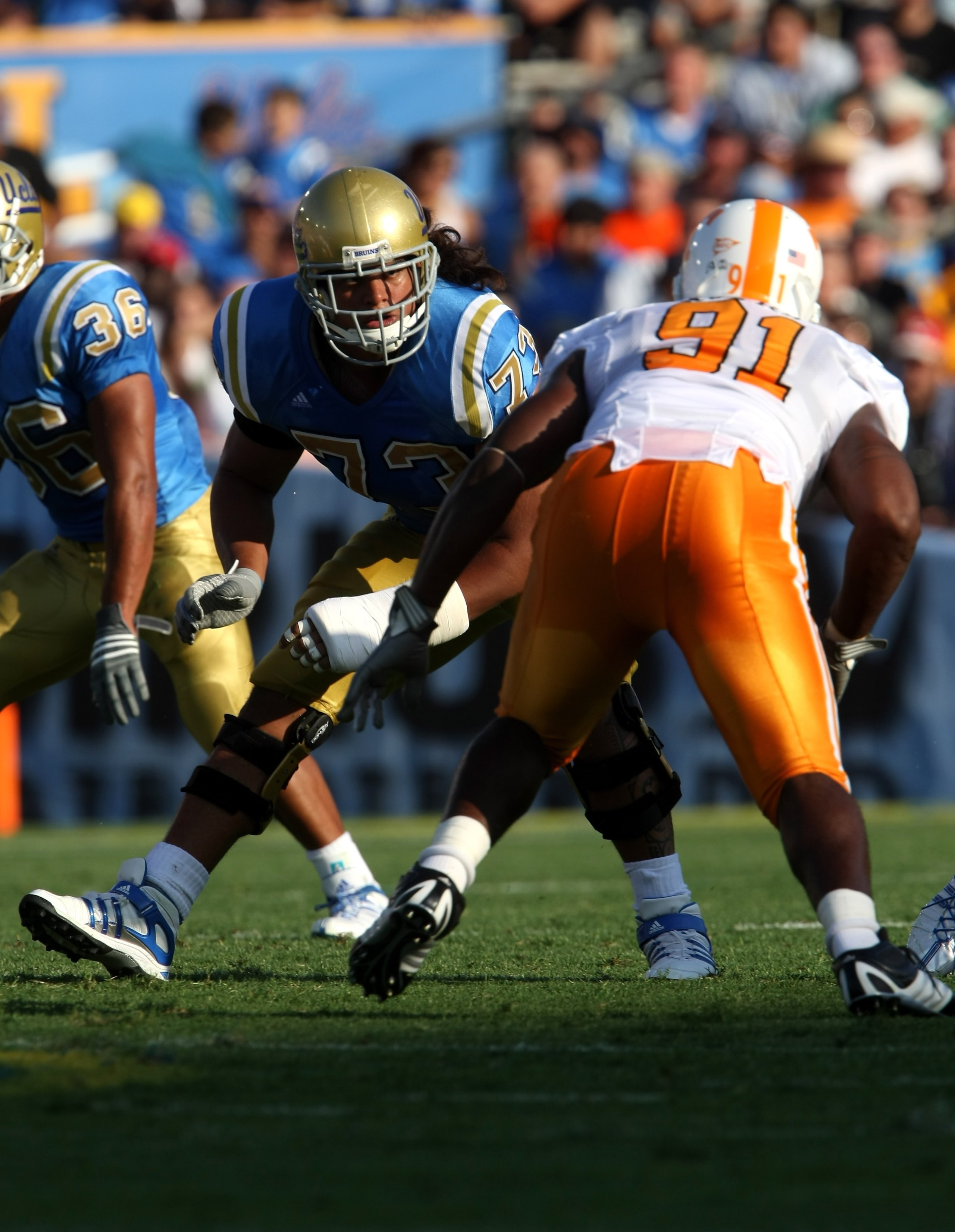 PASADENA, CA - SEPTEMBER 01:  Tackle Micah Kia #73 of the UCLA Bruins and defensive end Robert Ayers  #91 of the University of Tennessee Volunteers battle on the line of scrimmage on September 1, 2008 at the Rose Bowl in Pasadena, California.  UCLA won 27
