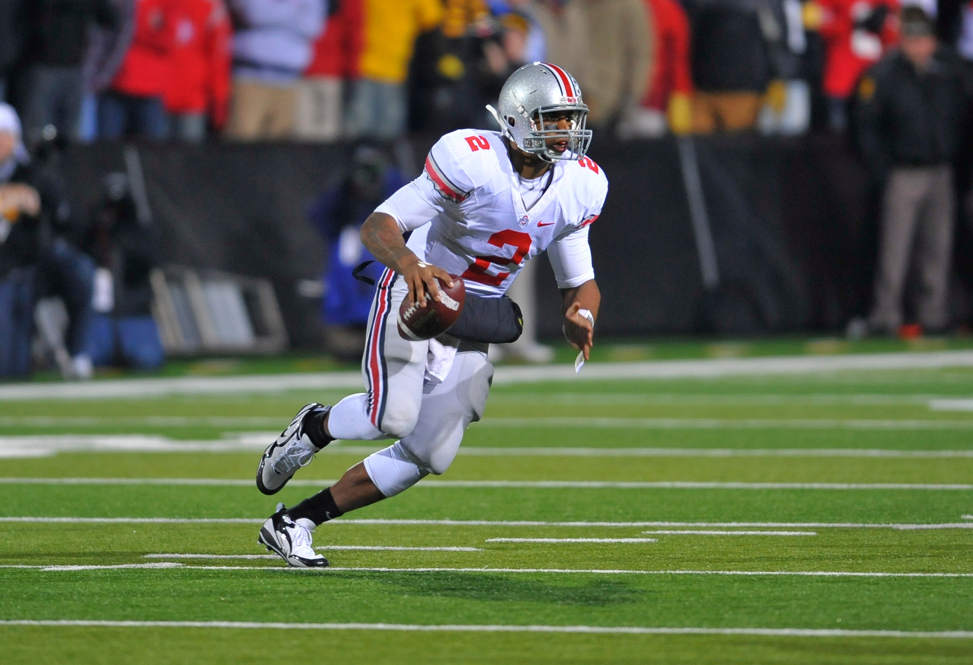 IOWA CITY, IA - NOVEMBER 20:  Quarterback Terrelle Pryor #2 of the Ohio State Buckeyes scrambles for yards under pressure from University of Iowa Hawkeyes defenders during the second half of play at Kinnick Stadium on November 20, 2010 in Iowa City, Iowa.