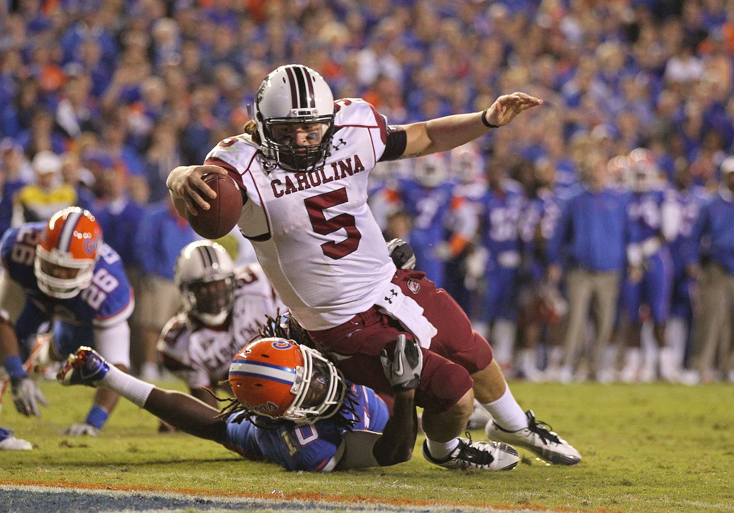 GAINESVILLE, FL - NOVEMBER 13:  Stephen Garcia #5 of the South Carolina Gamecocks rushes for a touchdown against Will Hill #10 of the Florida Gators during a game at Ben Hill Griffin Stadium on November 13, 2010 in Gainesville, Florida. The Gamecocks beat