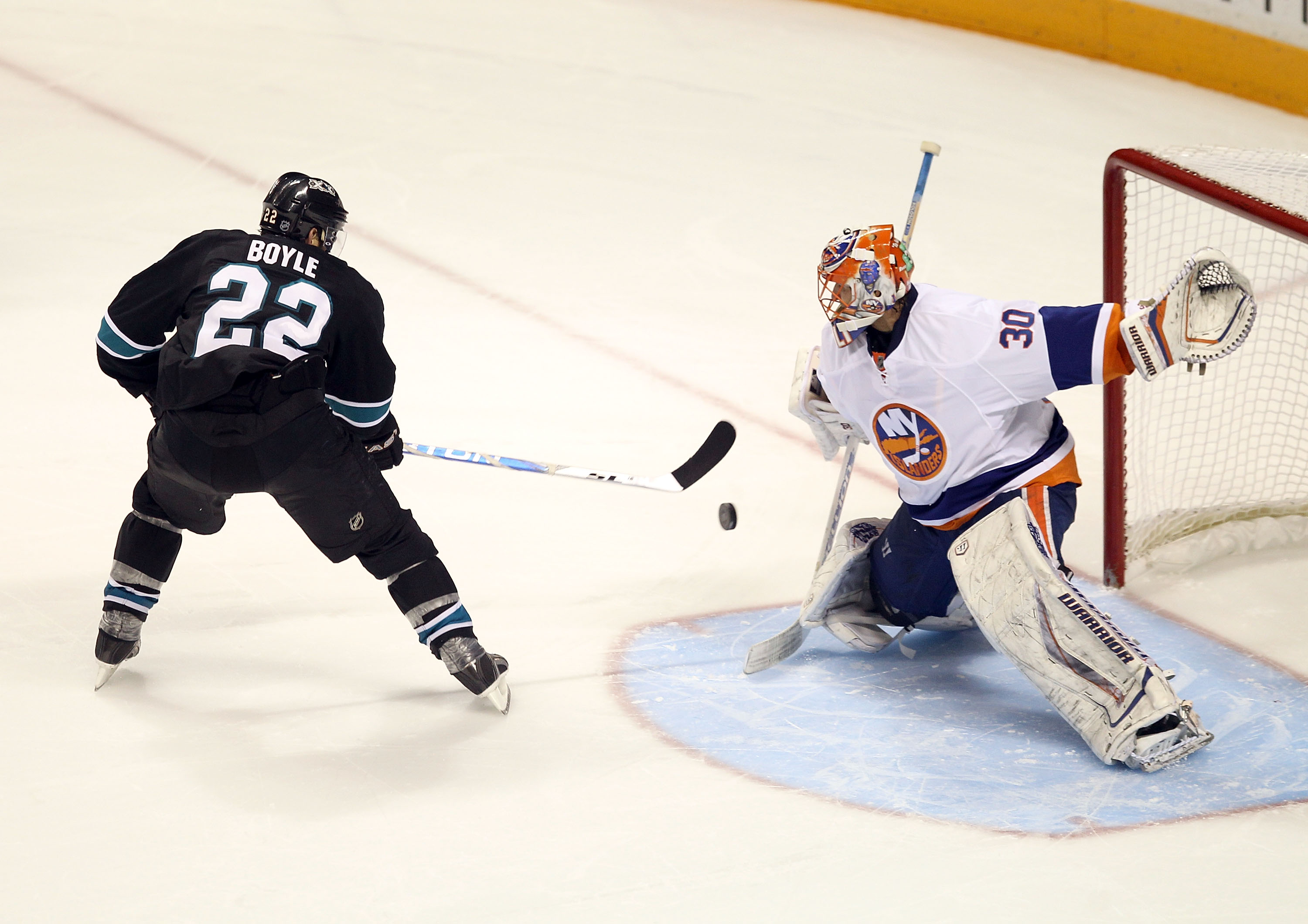 SAN JOSE, CA - NOVEMBER 11:  Dan Boyle #22 of the San Jose Sharks scores a goal past Dwayne Roloson #30 of the New York Islanders in a overtime shoot out to clinch the victory for the Sharks  on November 11, 2010 in San Jose, California.  (Photo by Ezra S
