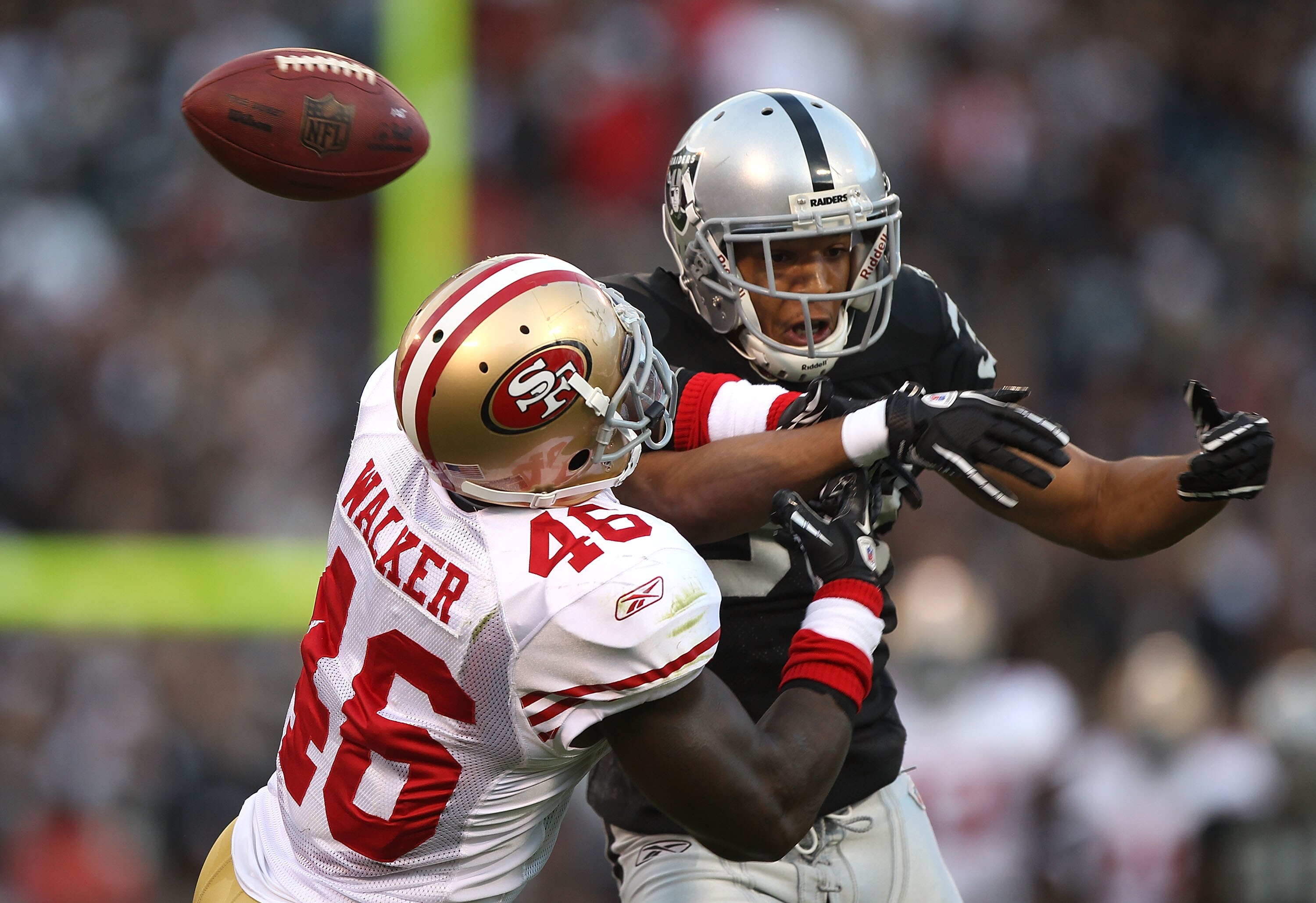 OAKLAND, CA - AUGUST 28:  Tyvon Branch #33 of the Oakland Raiders can't reach a pass as Delanie Walker #46 of the San Francisco 49ers defends during an NFL preseason game at Oakland-Alameda County Coliseum on August 28, 2010 in Oakland, California. (Photo