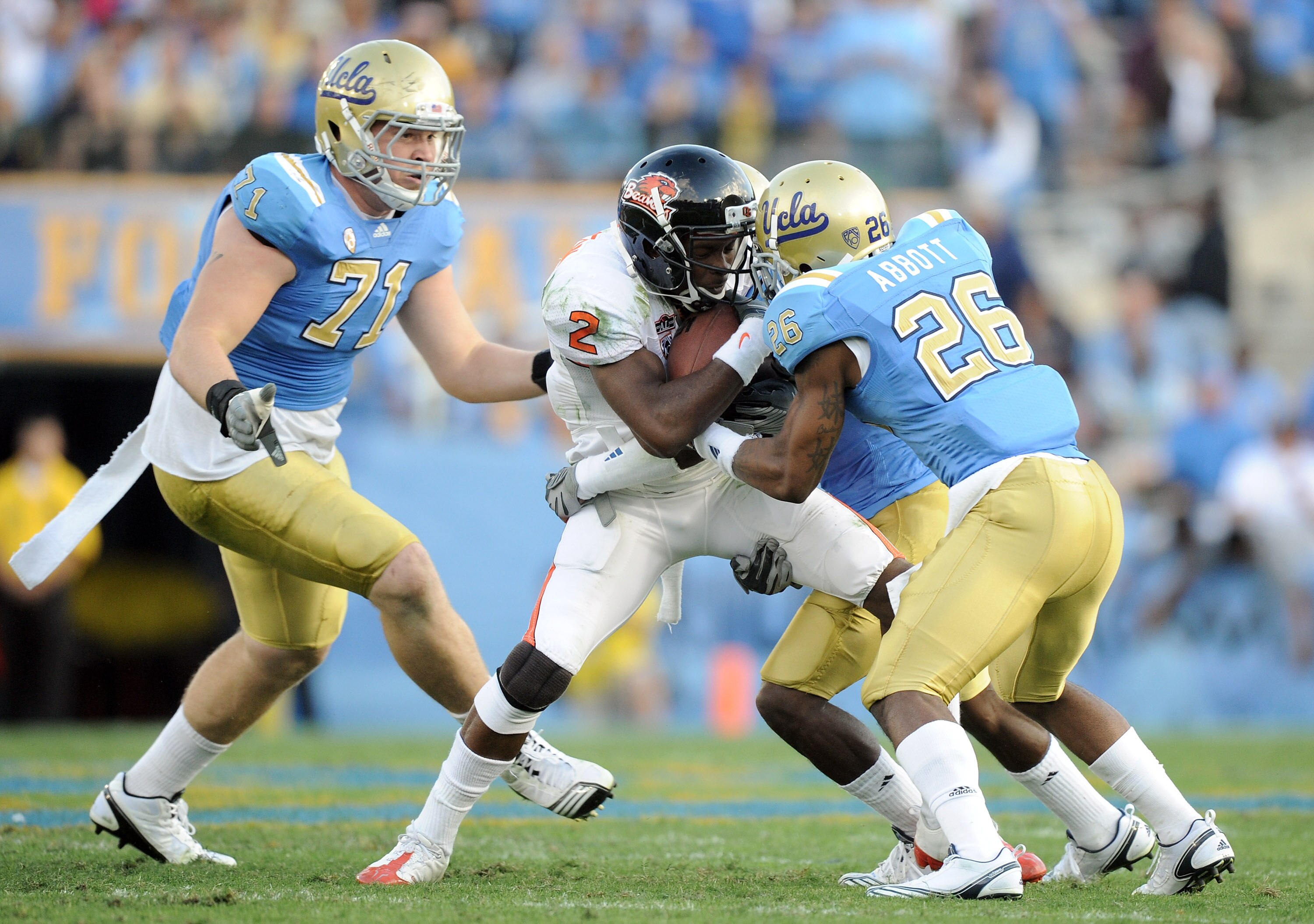 PASADENA, CA - NOVEMBER 06:  Markus Wheaton #2 of the Oregon State Beavers takes a hit from Andrew Abbott #26, Cassius Marsh #71 and Anthony Barr #2 of the UCLA Bruins during the second quarter at the Rose Bowl on November 6, 2010 in Pasadena, California.