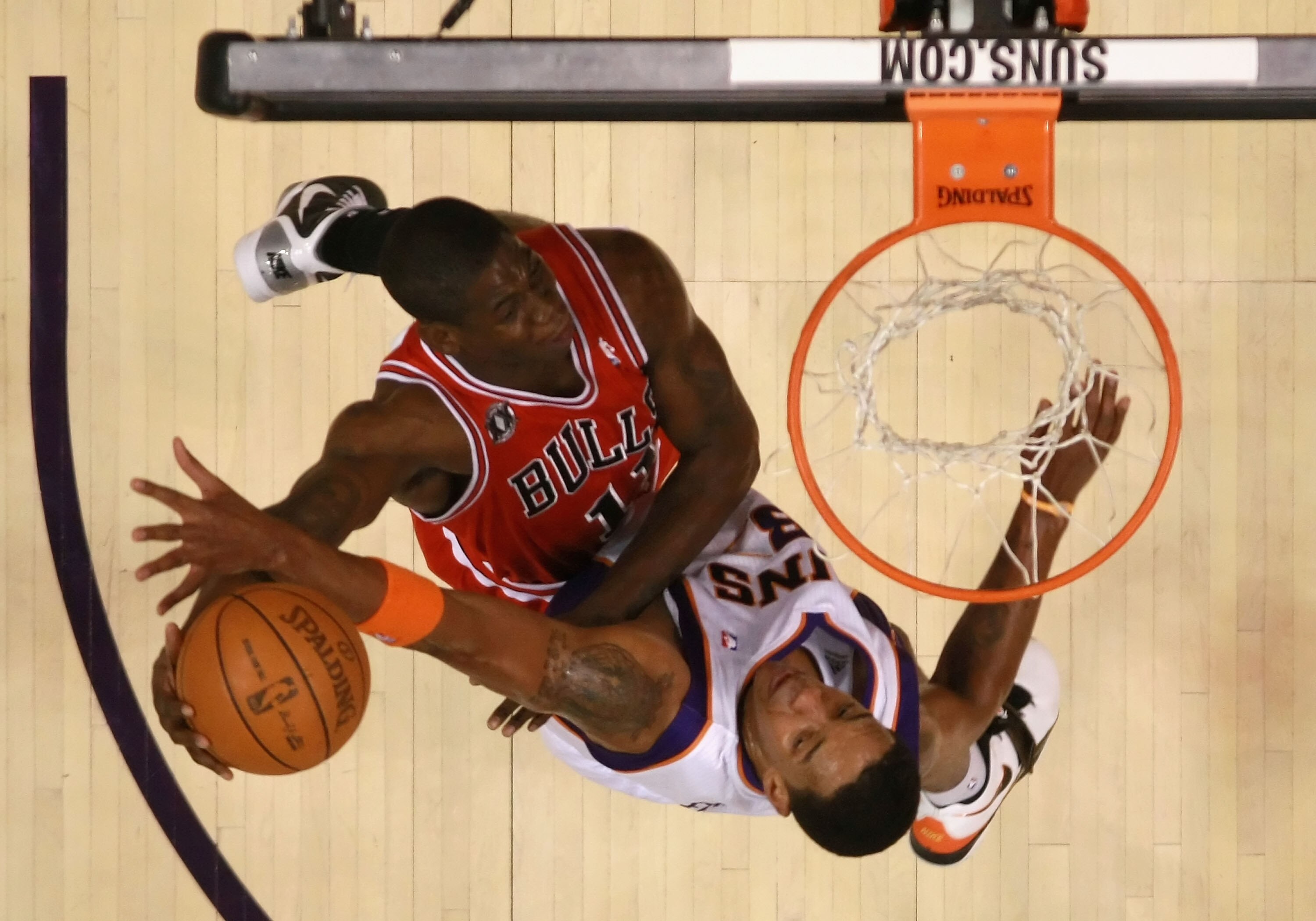 PHOENIX - NOVEMBER 24:  Ronnie Brewer #11 of the Chicago Bulls attempts a slam dunk over Channing Frye #8 of the Phoenix Suns during the NBA game at US Airways Center on November 24, 2010 in Phoenix, Arizona. The Bulls defeated the Suns 123-115 in double 