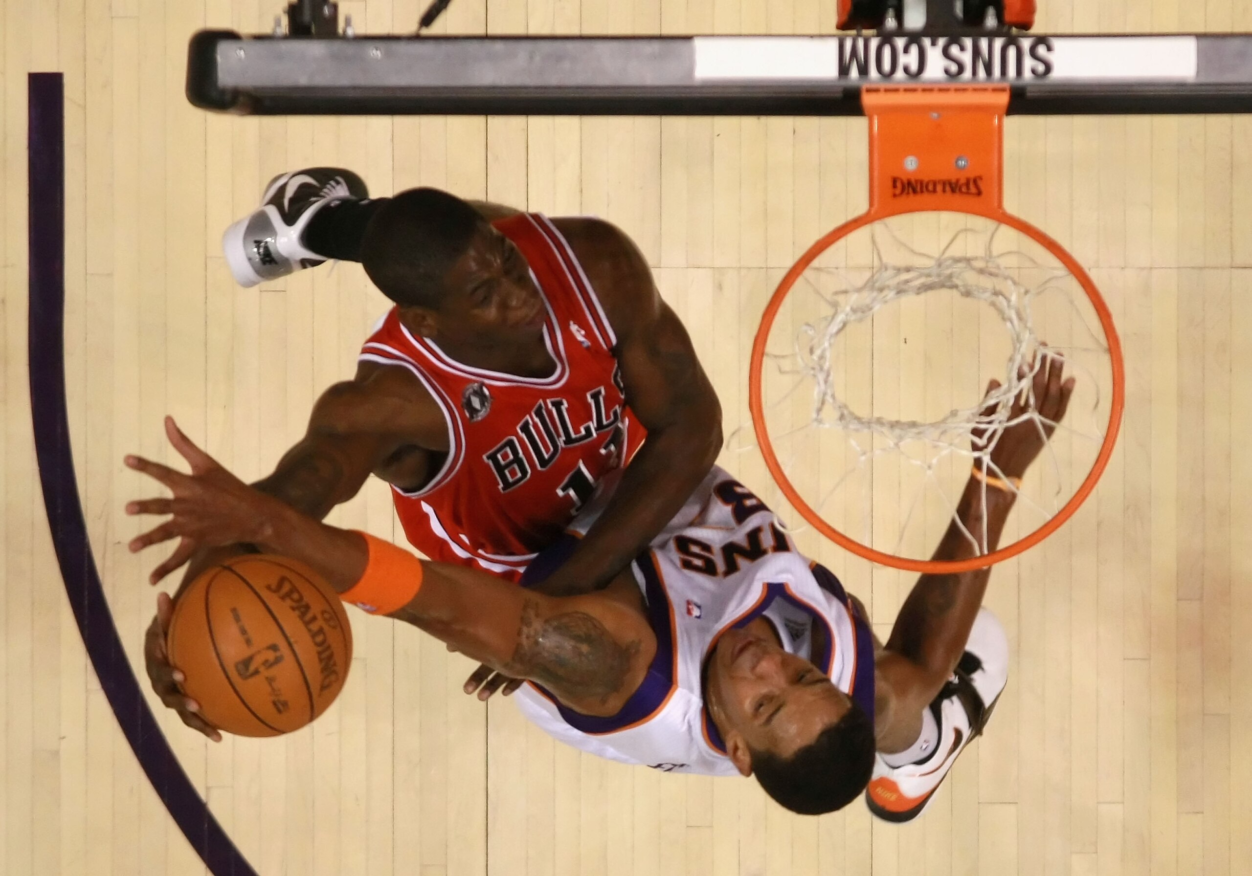 PHOENIX - NOVEMBER 24:  Ronnie Brewer #11 of the Chicago Bulls attempts a slam dunk over Channing Frye #8 of the Phoenix Suns during the NBA game at US Airways Center on November 24, 2010 in Phoenix, Arizona. The Bulls defeated the Suns 123-115 in double 