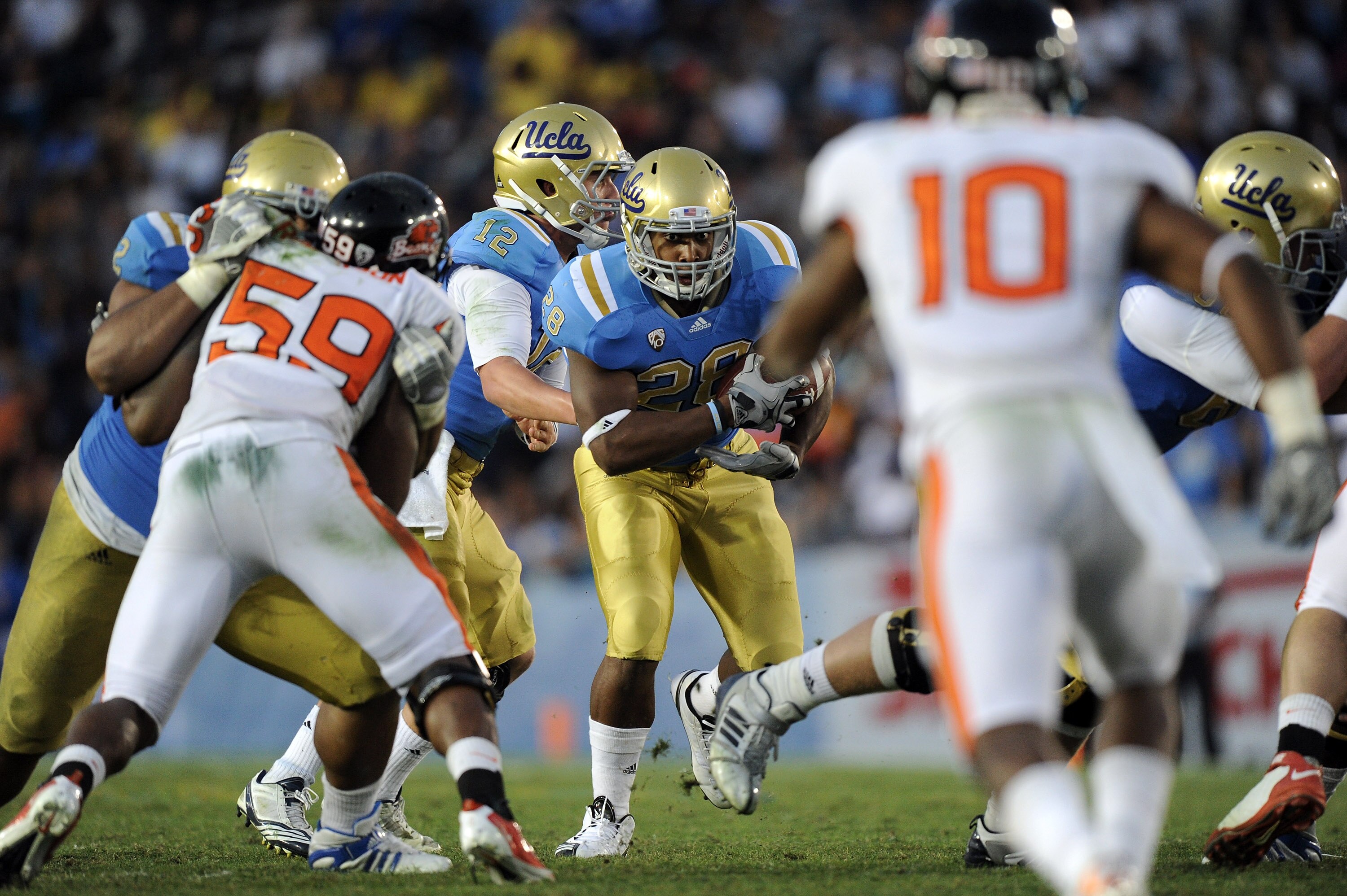 PASADENA, CA - NOVEMBER 06:  Malcolm Jones #28 of the UCLA Bruins takes a handoff against the Oregon State Beavers during the third quarter at the Rose Bowl on November 6, 2010 in Pasadena, California. UCLA won 17-14.   (Photo by Harry How/Getty Images)