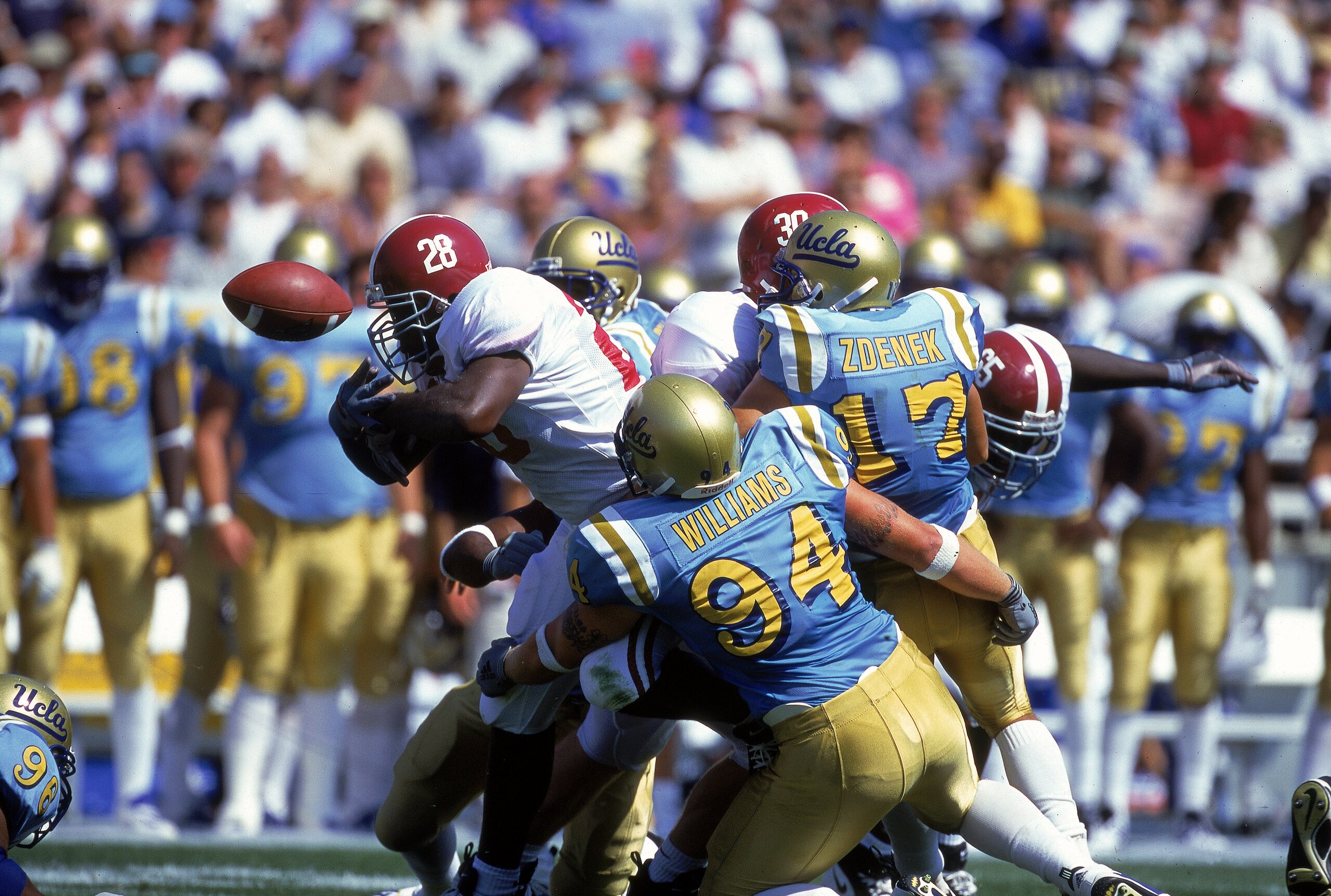 2 Sep 2000:  Shaun Bohanon #28 of the Alabama Crimson Tide has the ball knocked loose while Rusty Williams #94 and Jason Zdenek #17 of the UCLA Bruins try to tackle him at the Rose Bowl in Pasadena, California. The Bruins defeated the Crimson Tide 24-35.M