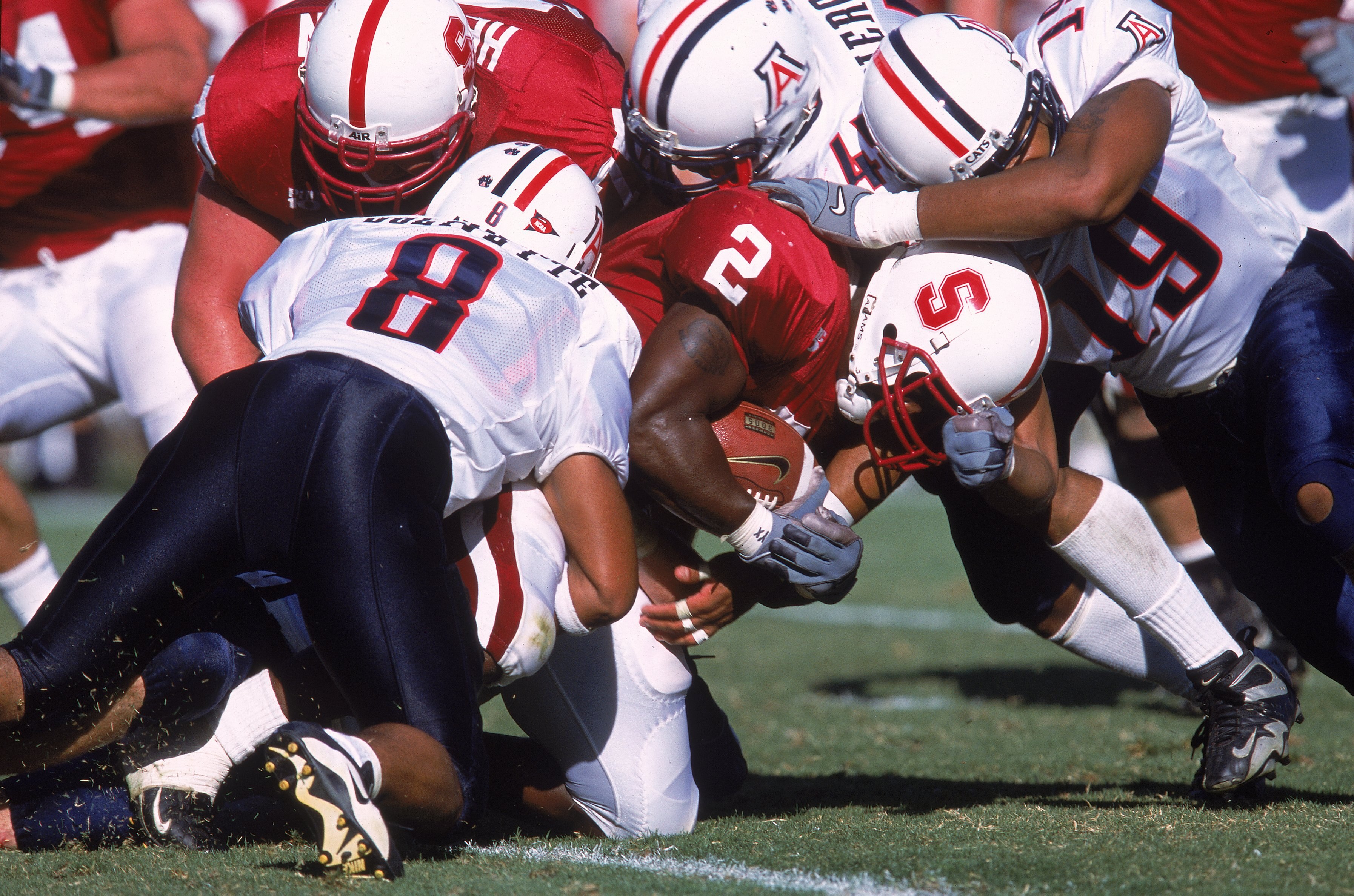 30 Sep 2000:  De Ronnie Pitts #2 of the Stanford Cardinals is tackled by Brandon Nash #19 and Michael Jolvivette #8 of the Arizona Wildcats during the game at Stanford Stadium in Palo Alto, California. The Wildcats defeated the Cardinals 27-3.Mandatory Cr