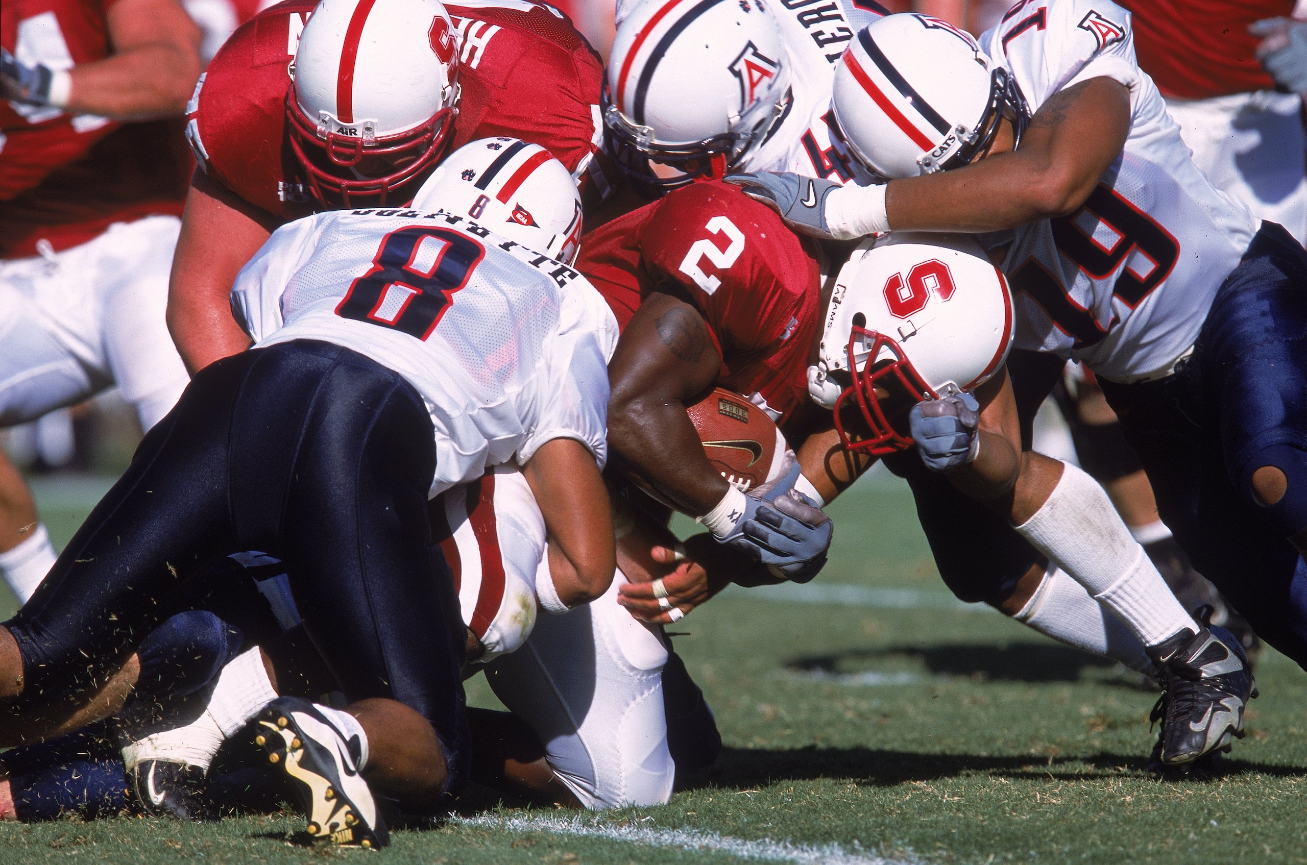 30 Sep 2000:  De Ronnie Pitts #2 of the Stanford Cardinals is tackled by Brandon Nash #19 and Michael Jolvivette #8 of the Arizona Wildcats during the game at Stanford Stadium in Palo Alto, California. The Wildcats defeated the Cardinals 27-3.Mandatory Cr