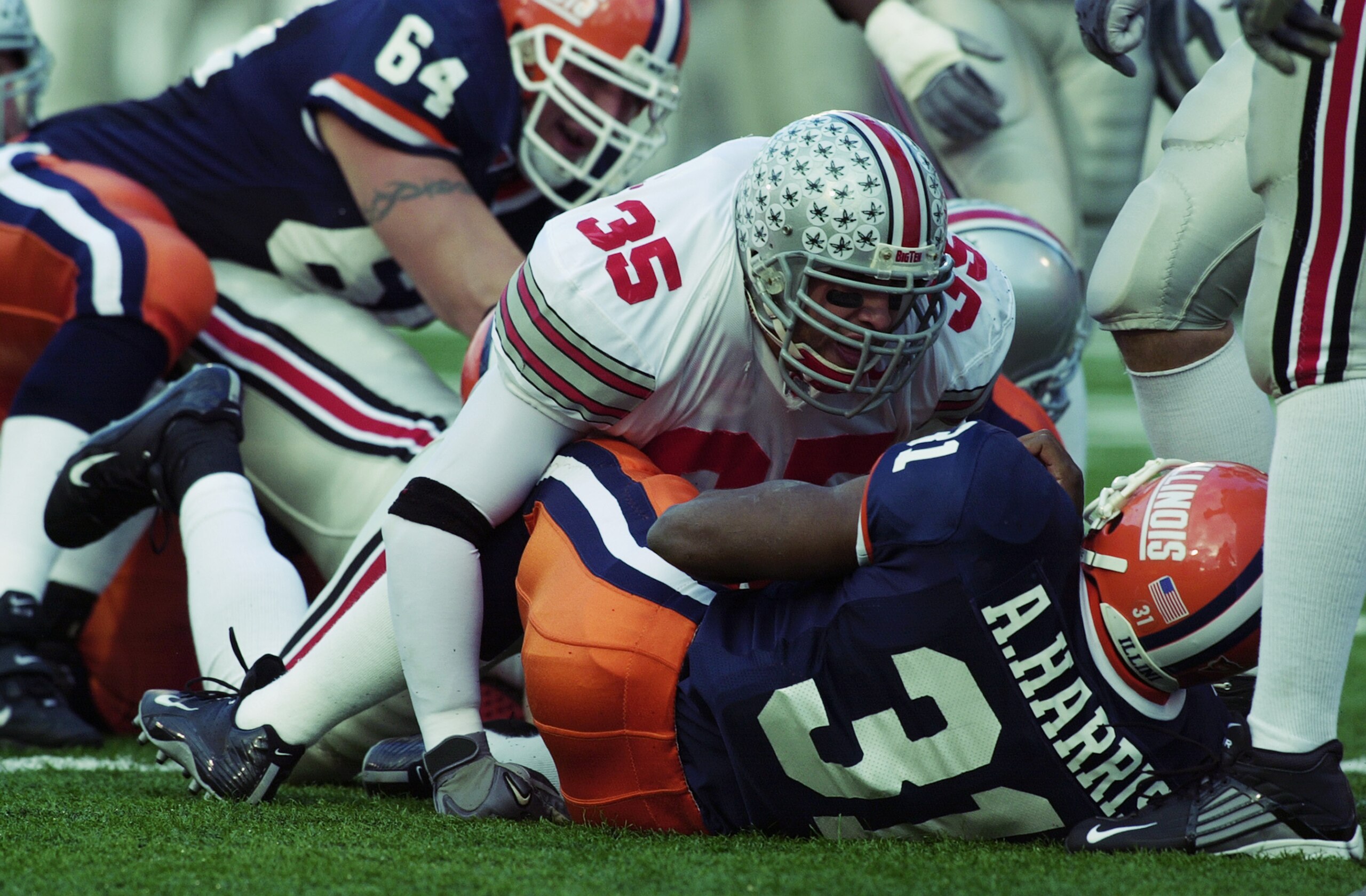 CHAMPAIGN, IL - NOVEMBER 16:  Linebacker Matt Wilhelm #35 of the Ohio State University Buckeyes tackles Antoineo Harris #31 of the University of Illinois Fighting Illini during the Big Ten game at Memorial Stadium on November 16, 2002 in Champaign, Illino