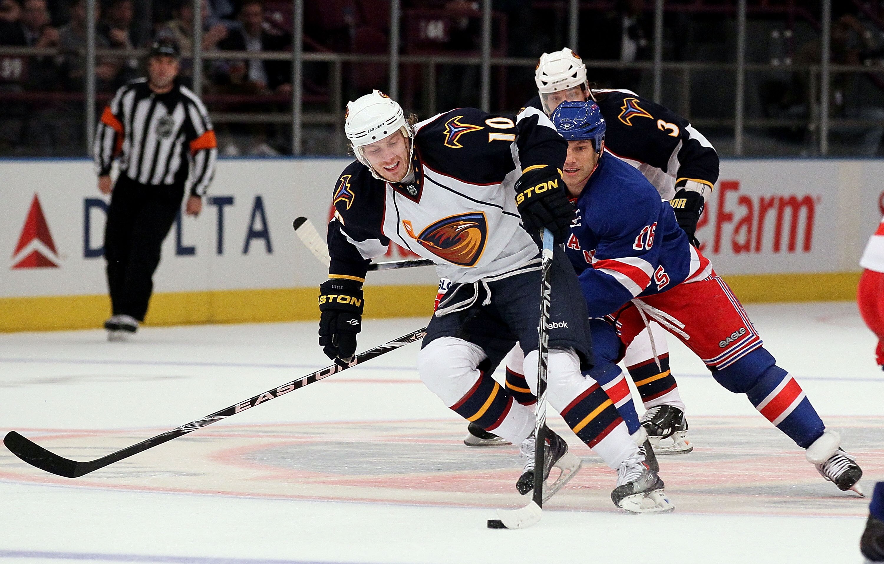 NEW YORK - OCTOBER 27:  Bryan Little #10 of the Atlanta Thrashers skates past Sean Avery #16 of the New York Rangers enroute to his first period goal on October 27, 2010 at Madison Square Garden in New York City.  (Photo by Jim McIsaac/Getty Images)