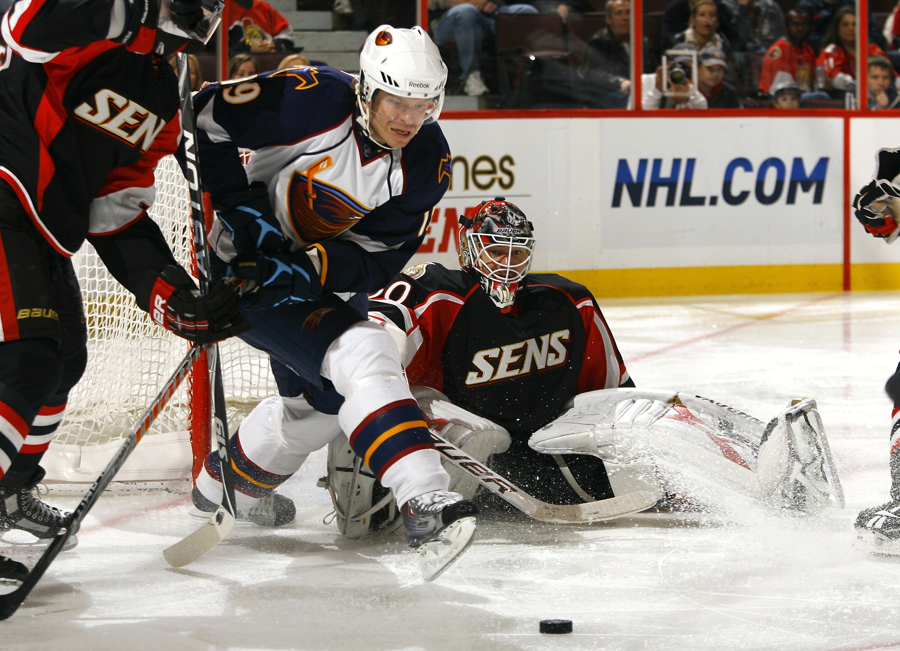 OTTAWA - NOVEMBER 09:  Freddy Modin #19 of the Atlanta Thrashers tries to get his stick on the puck out front of a sprawled Brian Elliott #30 of the Ottawa Senators during a game at Scotiabank Place on November 9, 2010 in Ottawa, Ontario, Canada.  The Ott
