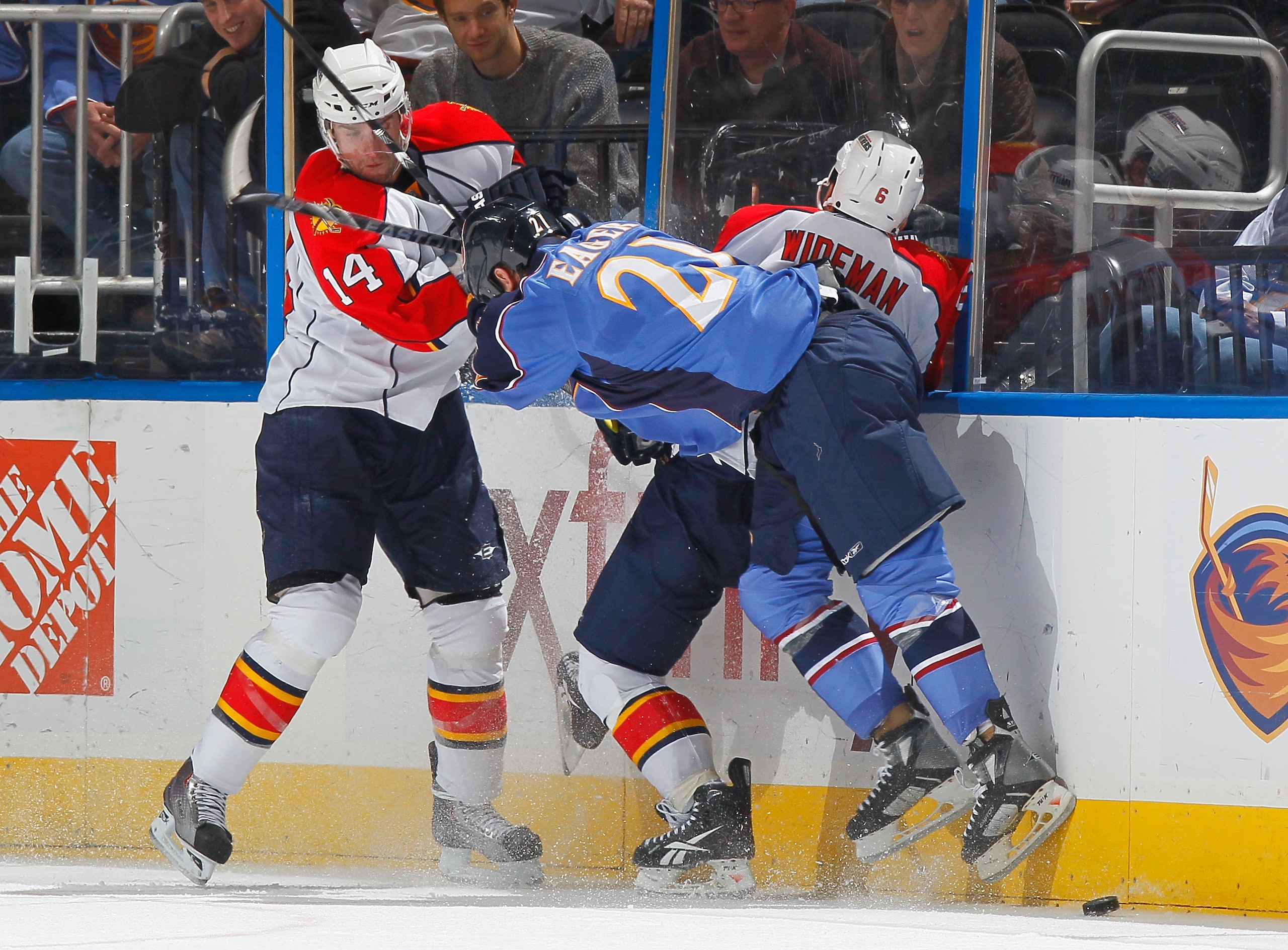 ATLANTA - NOVEMBER 17:  Ben Eager #21 of the Atlanta Thrashers battles for the puck against Radek Dvorak #14 and Dennis Wideman #6 of the Florida Panthers at Philips Arena on November 17, 2010 in Atlanta, Georgia.  (Photo by Kevin C. Cox/Getty Images)