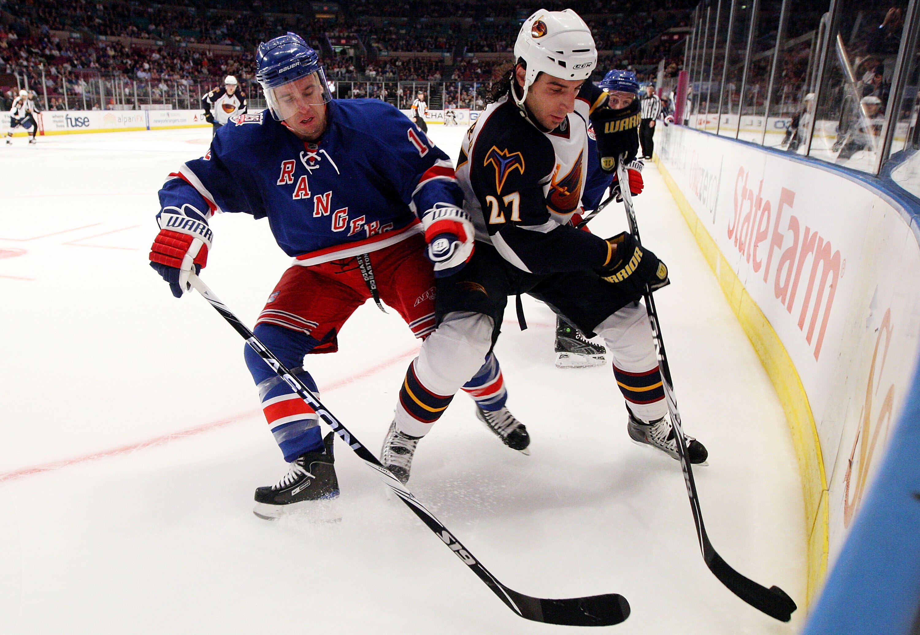 NEW YORK - OCTOBER 27:  Chris Thorburn #27 of the Atlanta Thrashers battles for the puck against Todd White #12 of the New York Rangers on October 27, 2010 at Madison Square Garden in New York City. Atlanta defeated the Rangers 6-4.  (Photo by Jim McIsaac