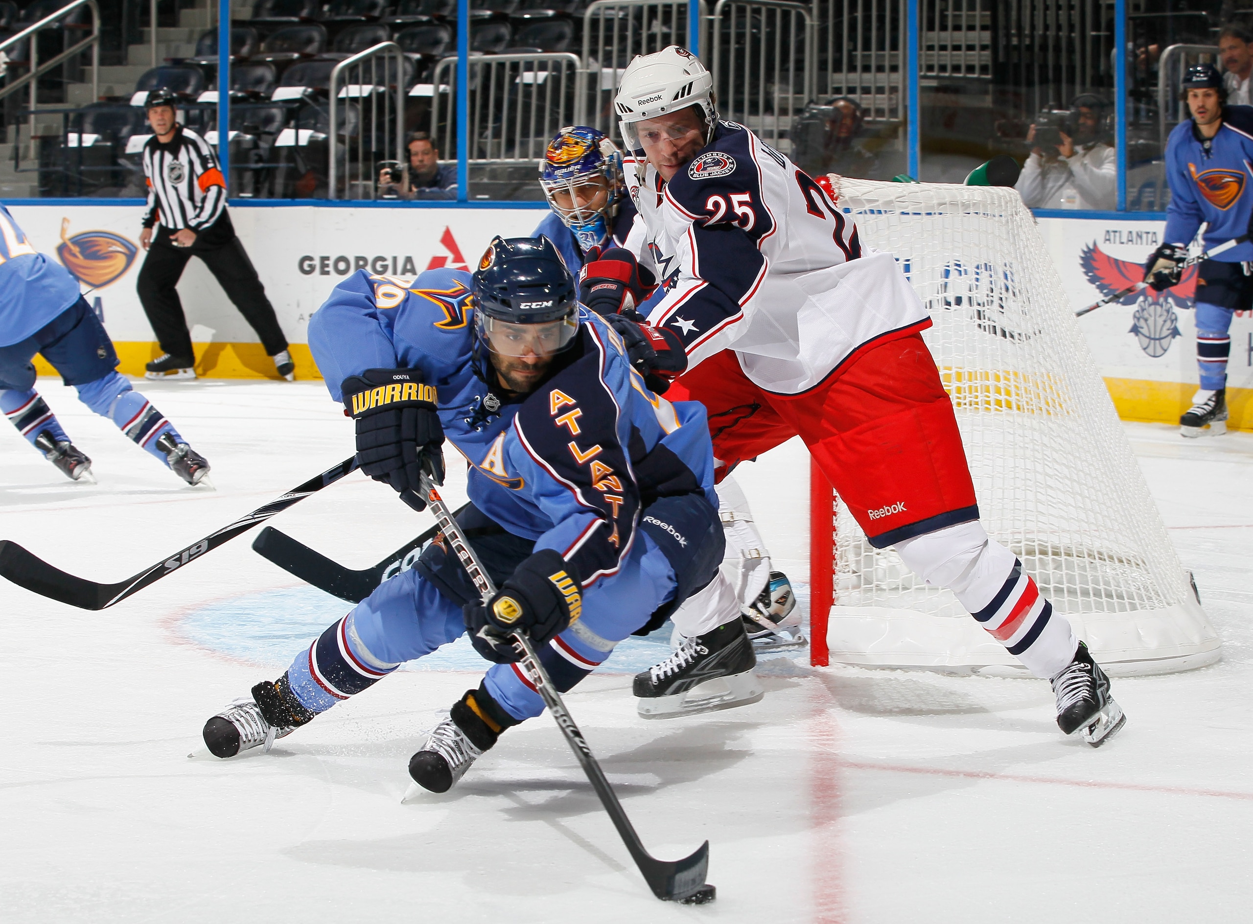 ATLANTA - NOVEMBER 04:  Johnny Oduya #29 of the Atlanta Thrashers controls the puck against Kyle Wilson #25 of the Columbus Blue Jackets at Philips Arena on November 4, 2010 in Atlanta, Georgia.  (Photo by Kevin C. Cox/Getty Images)