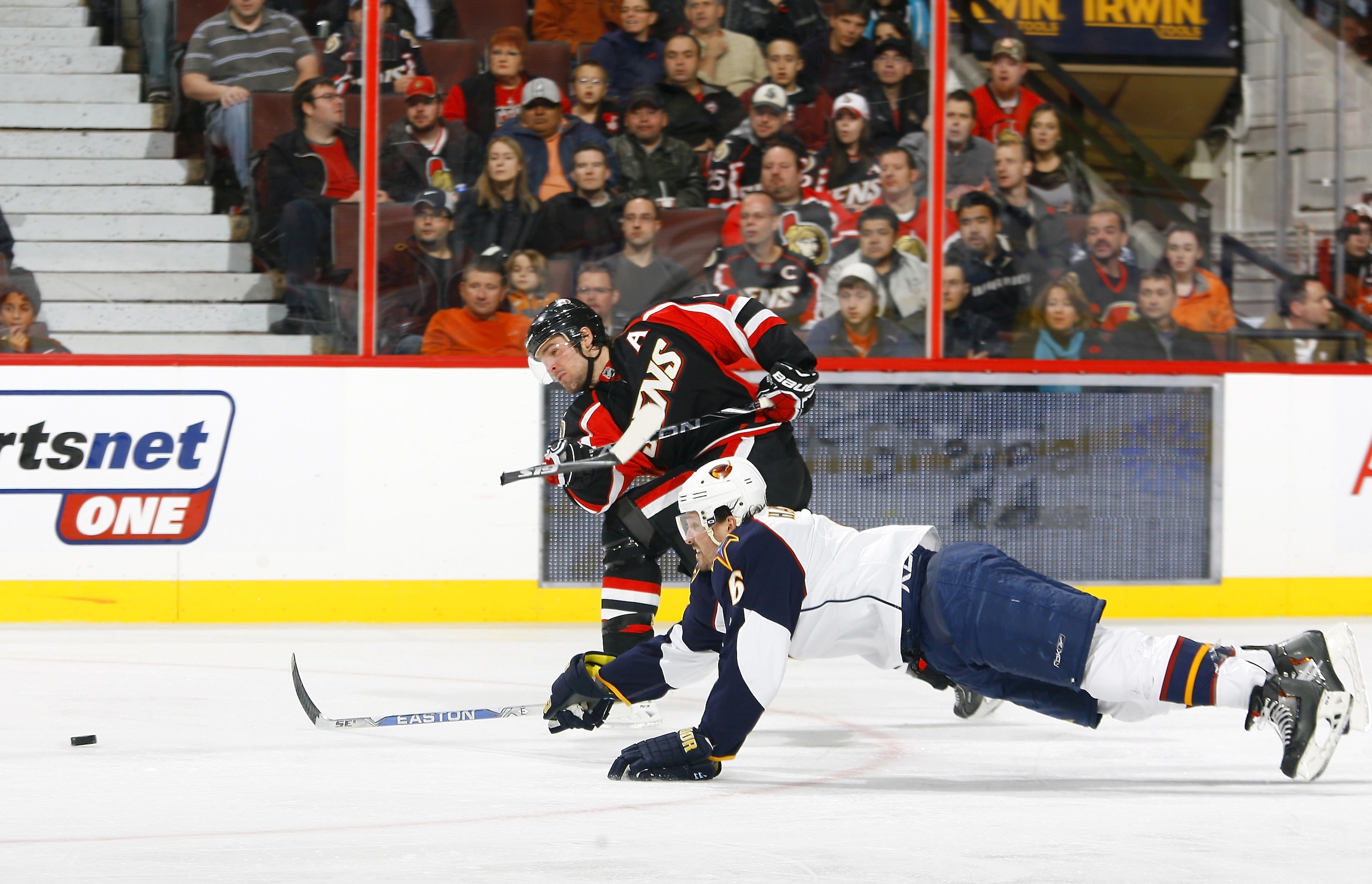 OTTAWA - NOVEMBER 09:  Mike Fisher #12 of the Ottawa Senators blows up his stick on a slapshot while Ron Hainsey #6 of the Atlanta Thrashers dives to block the puck during a game at Scotiabank Place on November 9, 2010 in Ottawa, Ontario, Canada.  (Photo