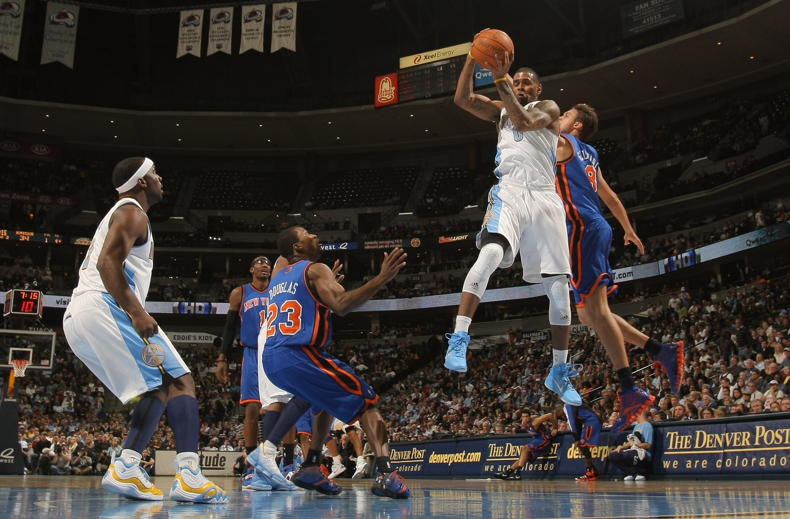 DENVER - NOVEMBER 16:  Gary Forbes #0 of the Denver Nuggets grabs a rebound away from Danilo Gallinari #8 of the New York Knicks as Toney Douglas #23 of the Knicks and Ty Lawson #3 of the Nuggets follow the action at the Pepsi Center on November 16, 2010