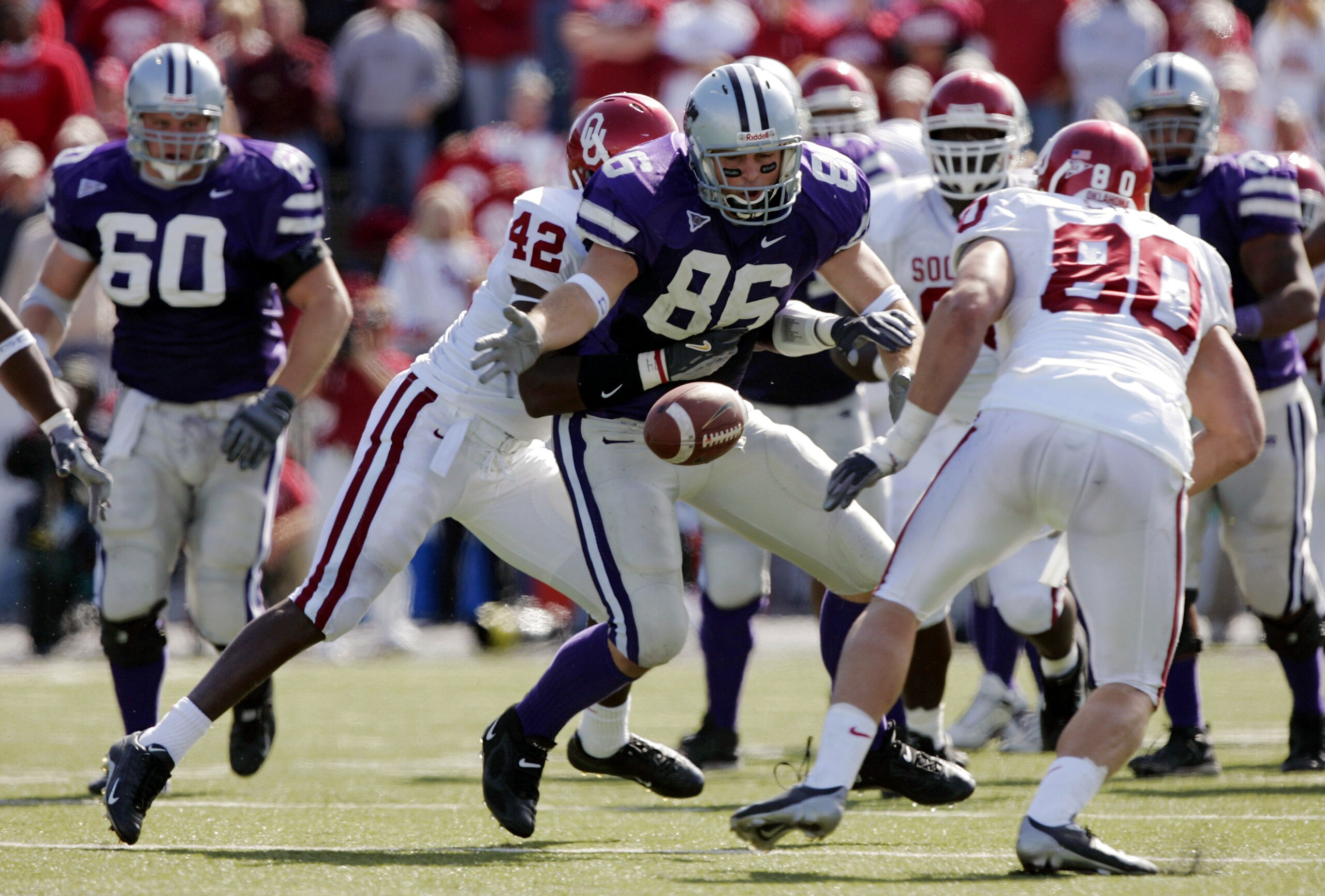MANHATTAN, KS - OCTOBER 16:  Linebacker Rufus Alexander #42 of the Oklahoma Sooners hits tight end Brian Casey #86 of the Kansas State Wildcats to cause a fumble and turnover in the third quarter on October 16, 2004 at KSU Stadium in Manhattan, Kansas. Th