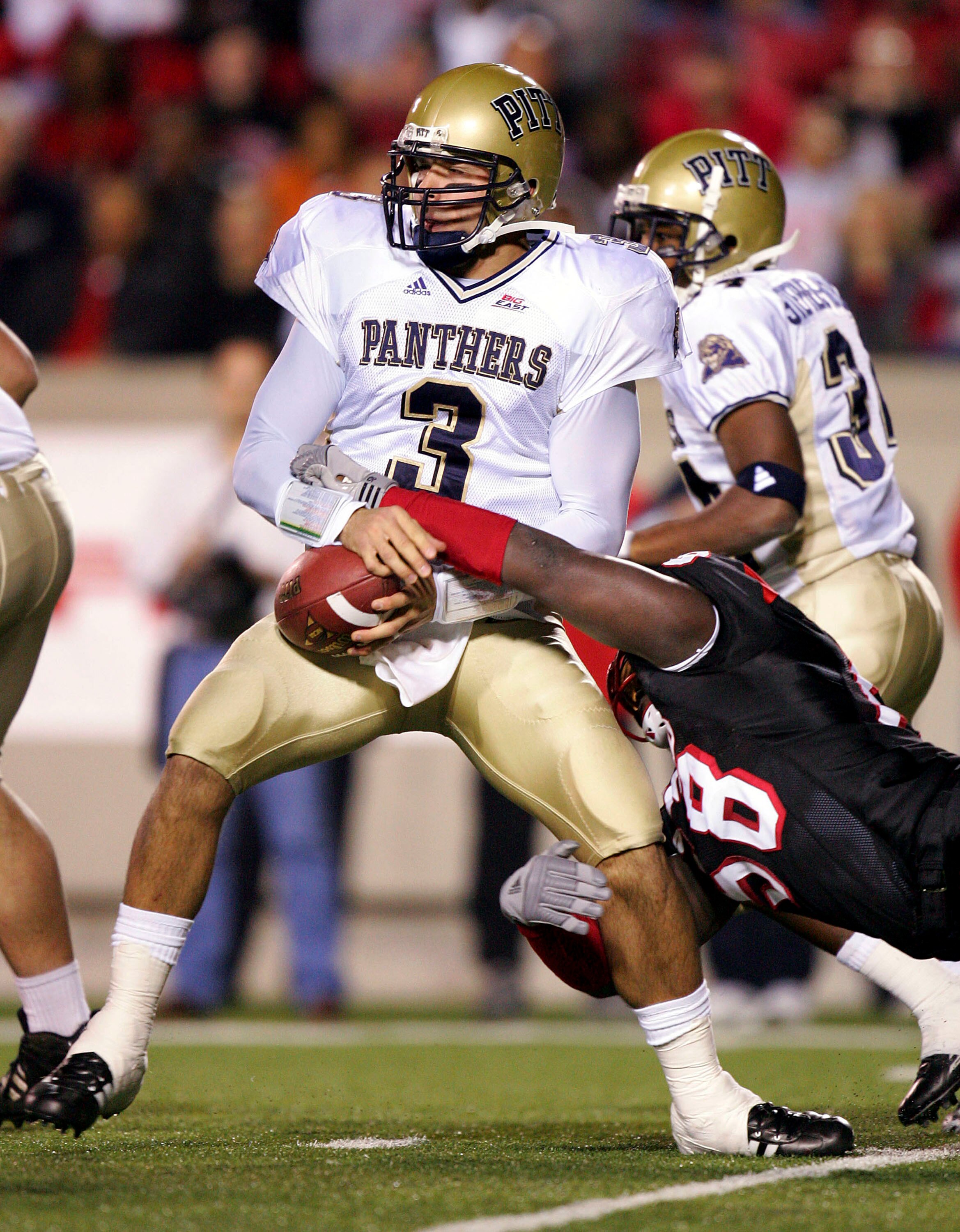 LOUISVILLE, KY - NOVEMBER 3:  Elvis Dumervil #58 of the Louisville Cardinals tackles TylerPalko #3 of the Pittsburgh Panthers during the game at Papa John's Stadium on November 3 17, 2005 in Louisville, Kentucky.    (Photo by Andy Lyons/Getty Images)