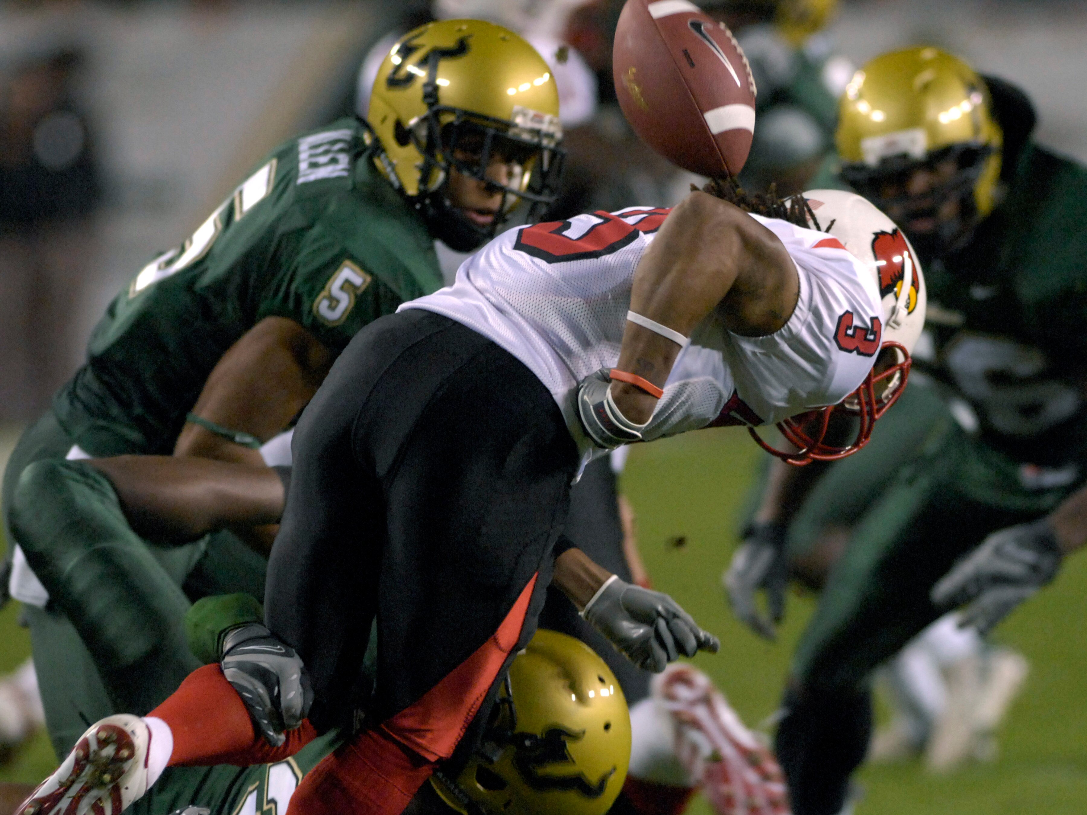 TAMPA, FL - NOVEMBER 17: Wide receiver Trent Guy #3 of the Louisville Cardinals fumbles the opening kickoff against the University of South Florida Bulls at Raymond James Stadium on November 17, 2007 in Tampa, Florida.  USF scored on the recovery and won
