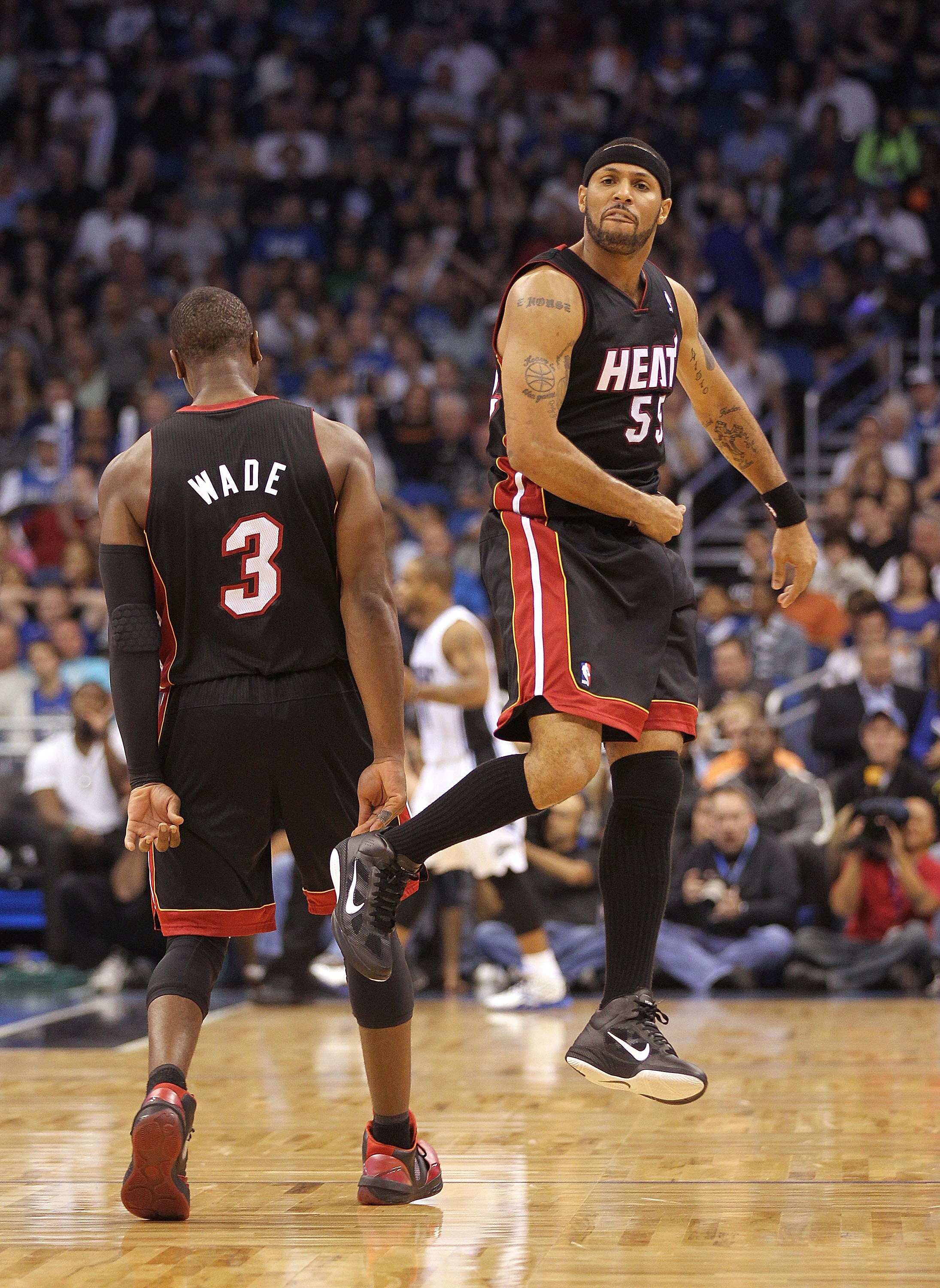ORLANDO, FL - NOVEMBER 24: Eddie House #55 of the Miami Heat is congratulated by Dwyane Wade #3 after making a 3 pointer during a game against the Orlando Magic at Amway Arena on November 24, 2010 in Orlando, Florida. NOTE TO USER: User expressly acknowle